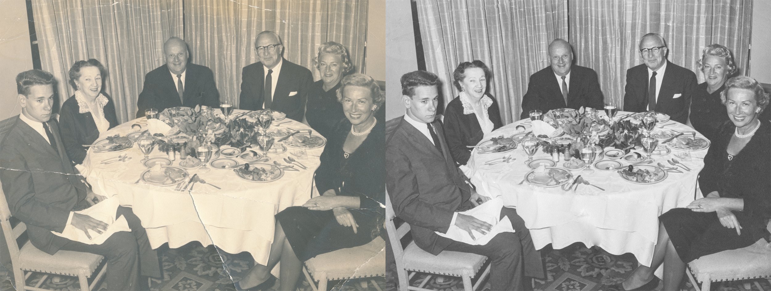 A vintage photo of six adults and one young man seated around a round dining table, set with plates, glasses, and floral arrangements, in a formal indoor setting with curtains in the background.