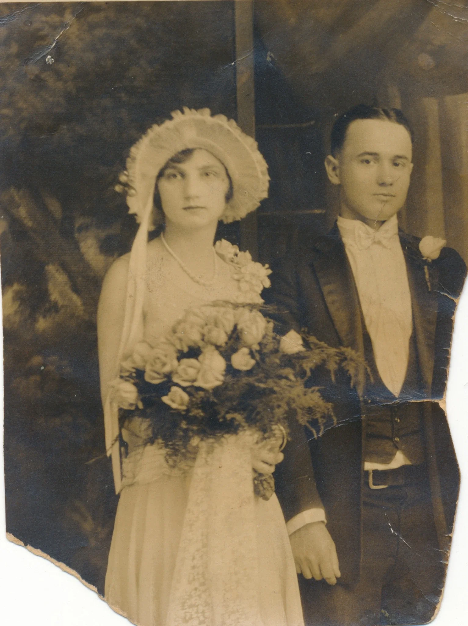 A vintage sepia photograph of a bride and groom on their wedding day.