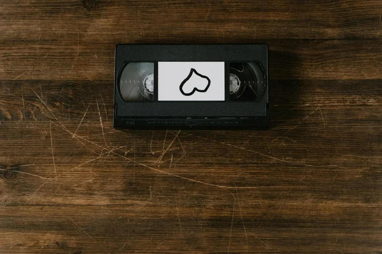 A black VHS tape with a white label featuring a black heart outline