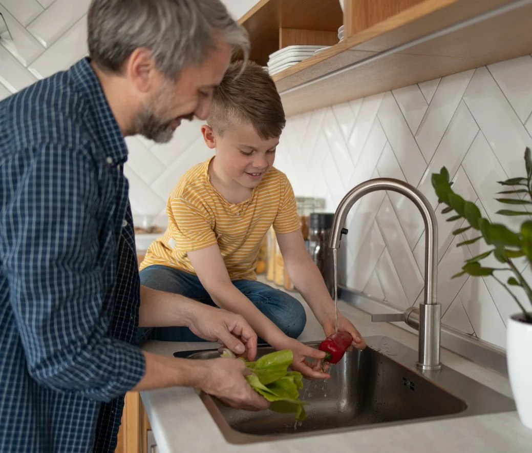father and son at kitchen sink