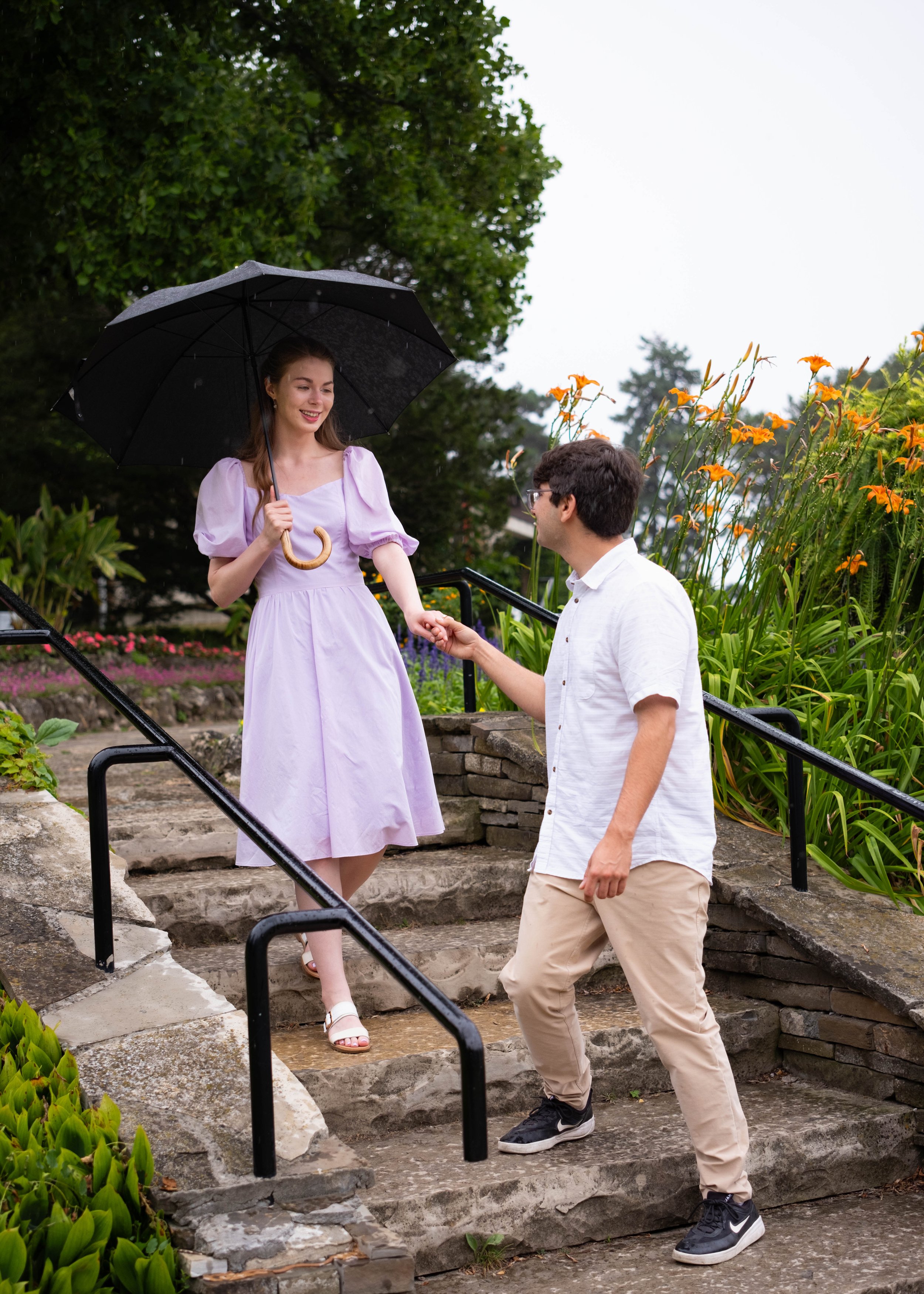 A couple walking down the stairs in the rain