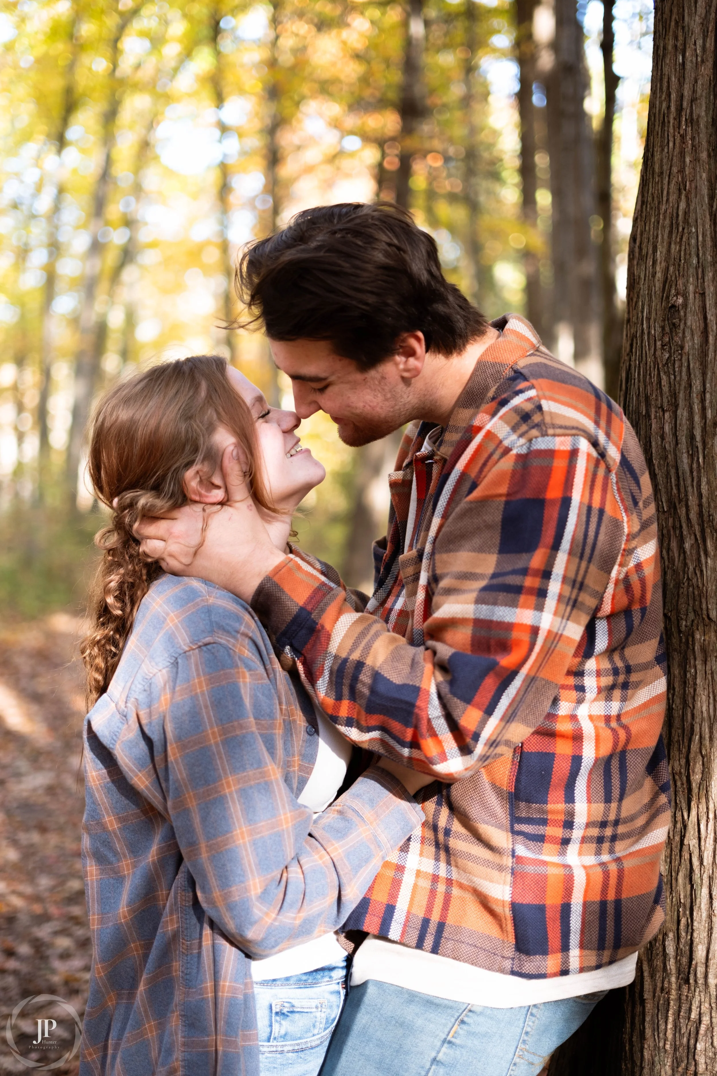 Couple in plaid embracing in a forest