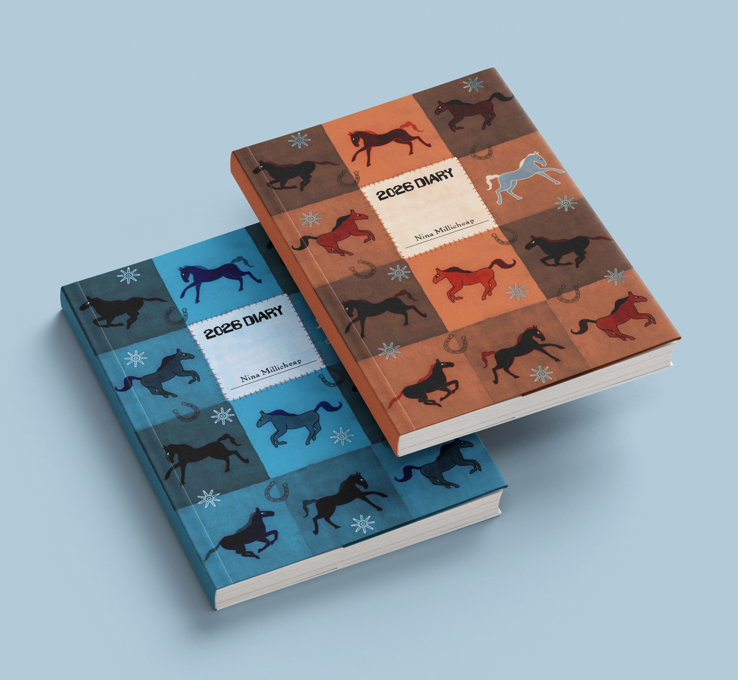 Two 2026 diary notebooks, one with a brown cover and the other with a blue cover, featuring colorful horse and star illustrations.