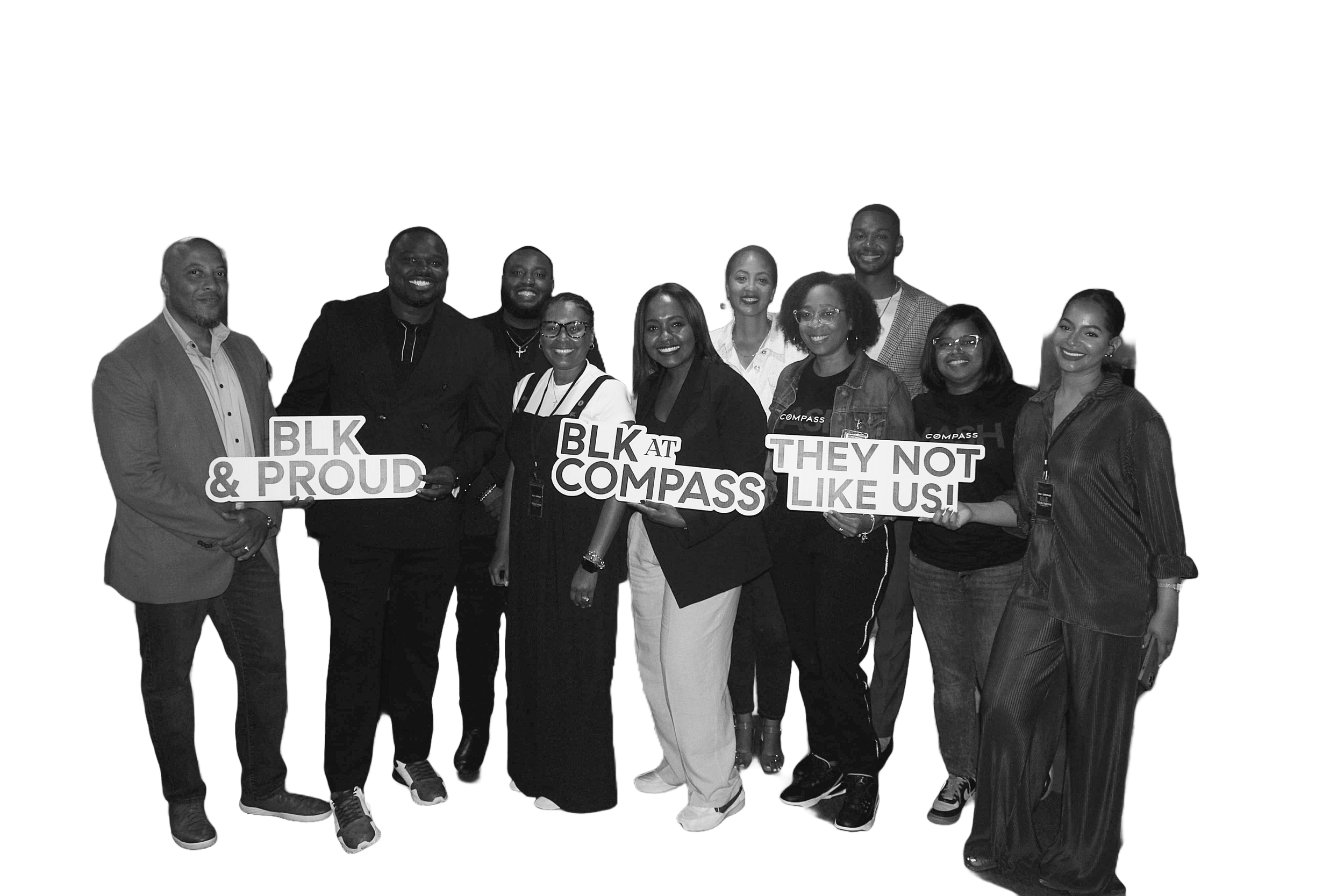 Group of diverse people holding signs that read 'BLK & PROUD', 'BLK AT COMPASS', and 'THEY NOT LIKE US!'