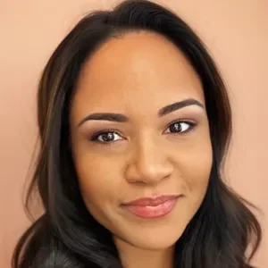 Close-up portrait of a young woman with dark hair and a slight smile.