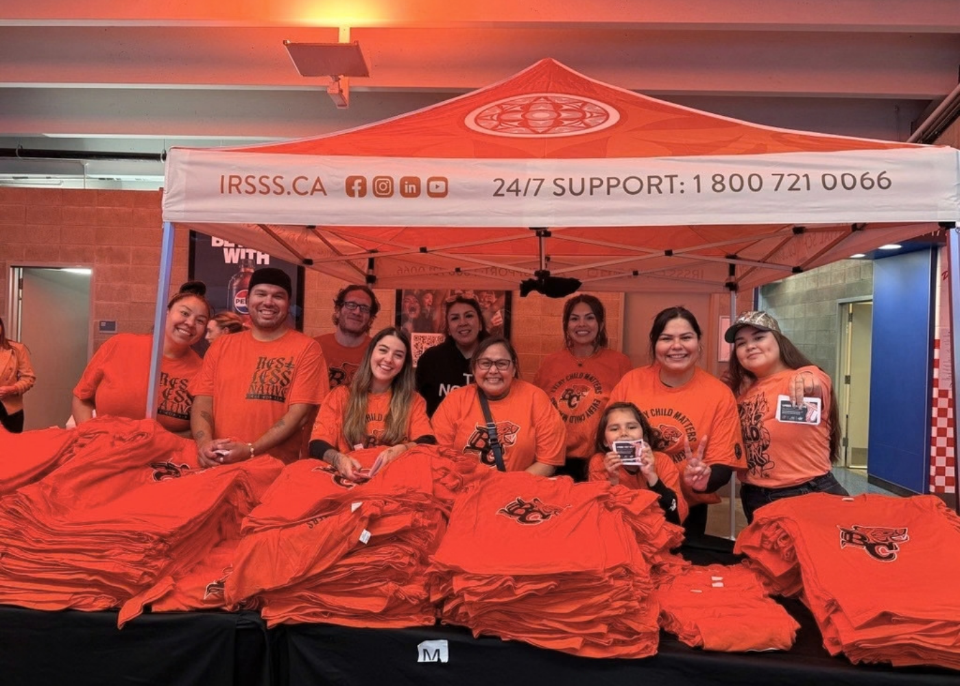  IRSSS Staff handing out BC Lions Every Child Matters shirts before the game on Friday, Sept 25. 10,000 free shirts were given away at this game, courtesy of the BC Lions. 