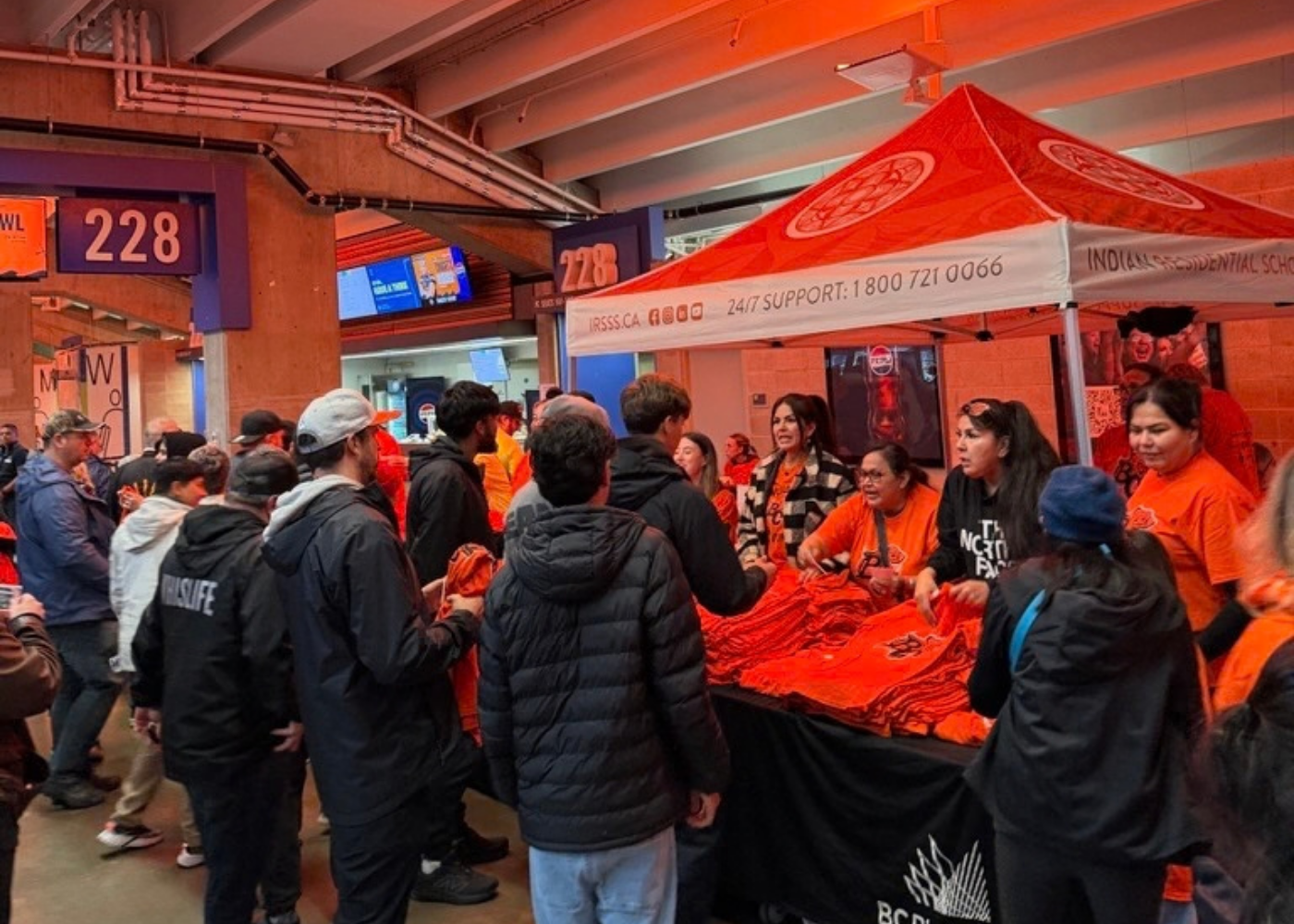  Attendees lining up for their free BC Lions Every Child Matters shirts 