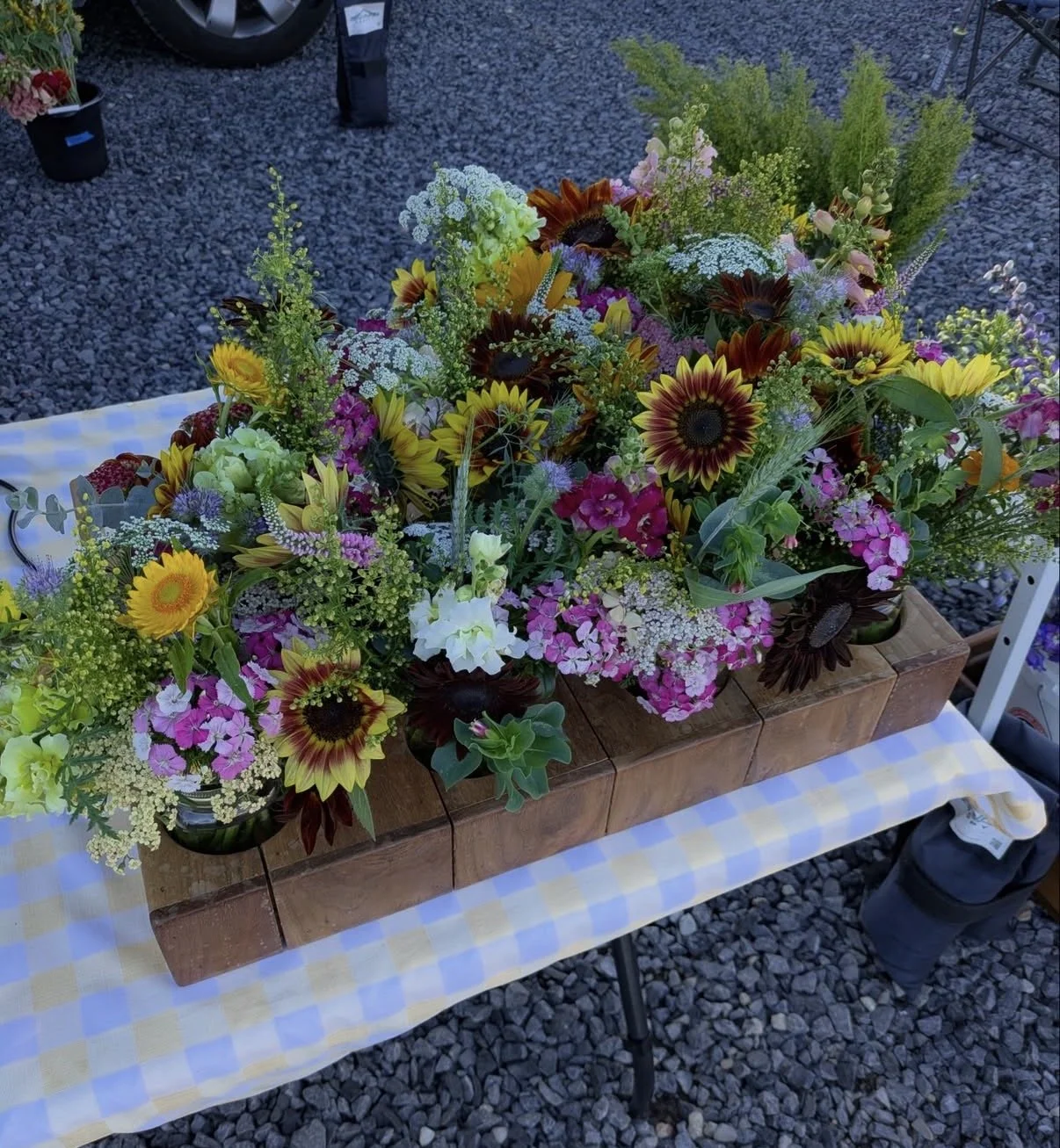 Farmer's market stands for Baby T-Rex Farm's flower bouquets.
