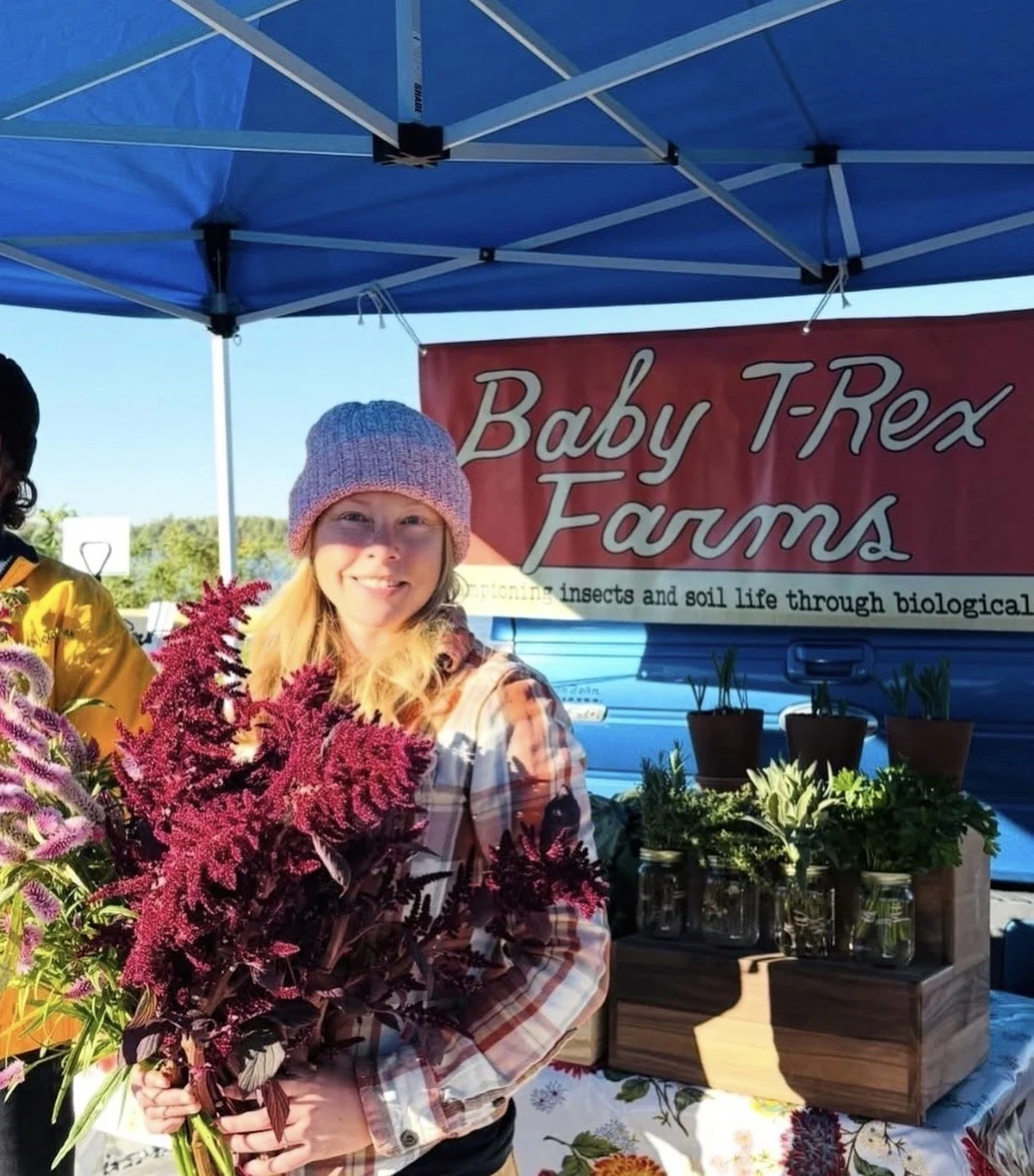 Farmer's market stands for Baby T-Rex Farm's flower bouquets.