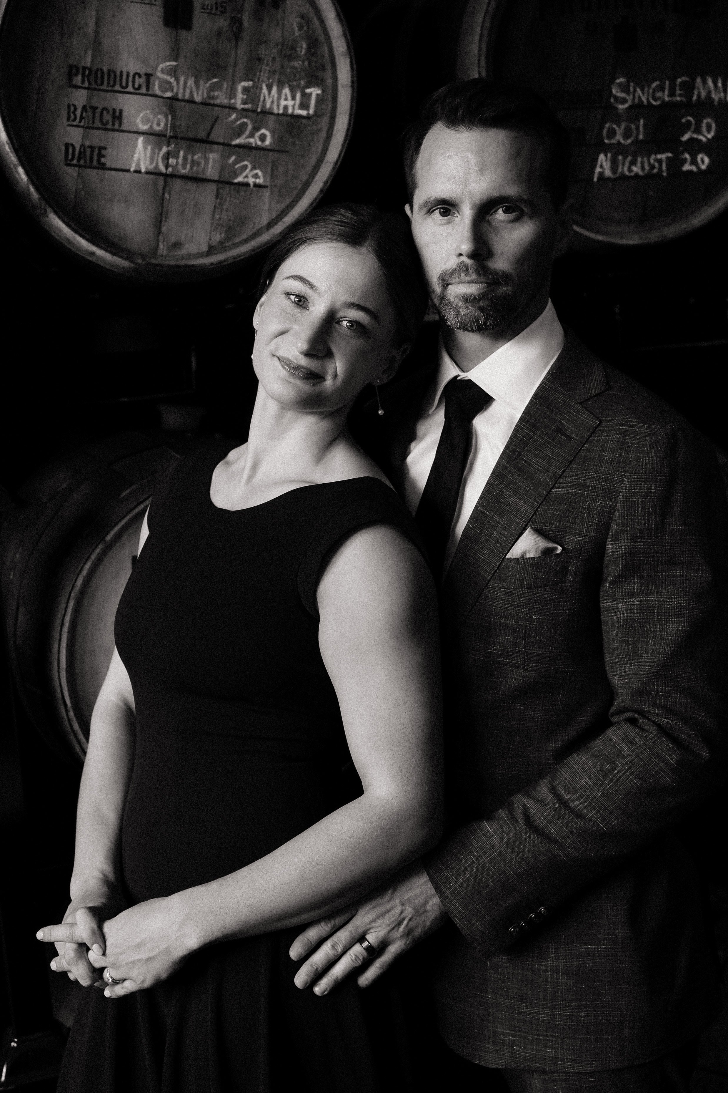A bride and groom stand embraced within each others arms, looking at the camera. Photographed by Adelaide wedding photographer, Woodley Photography. 