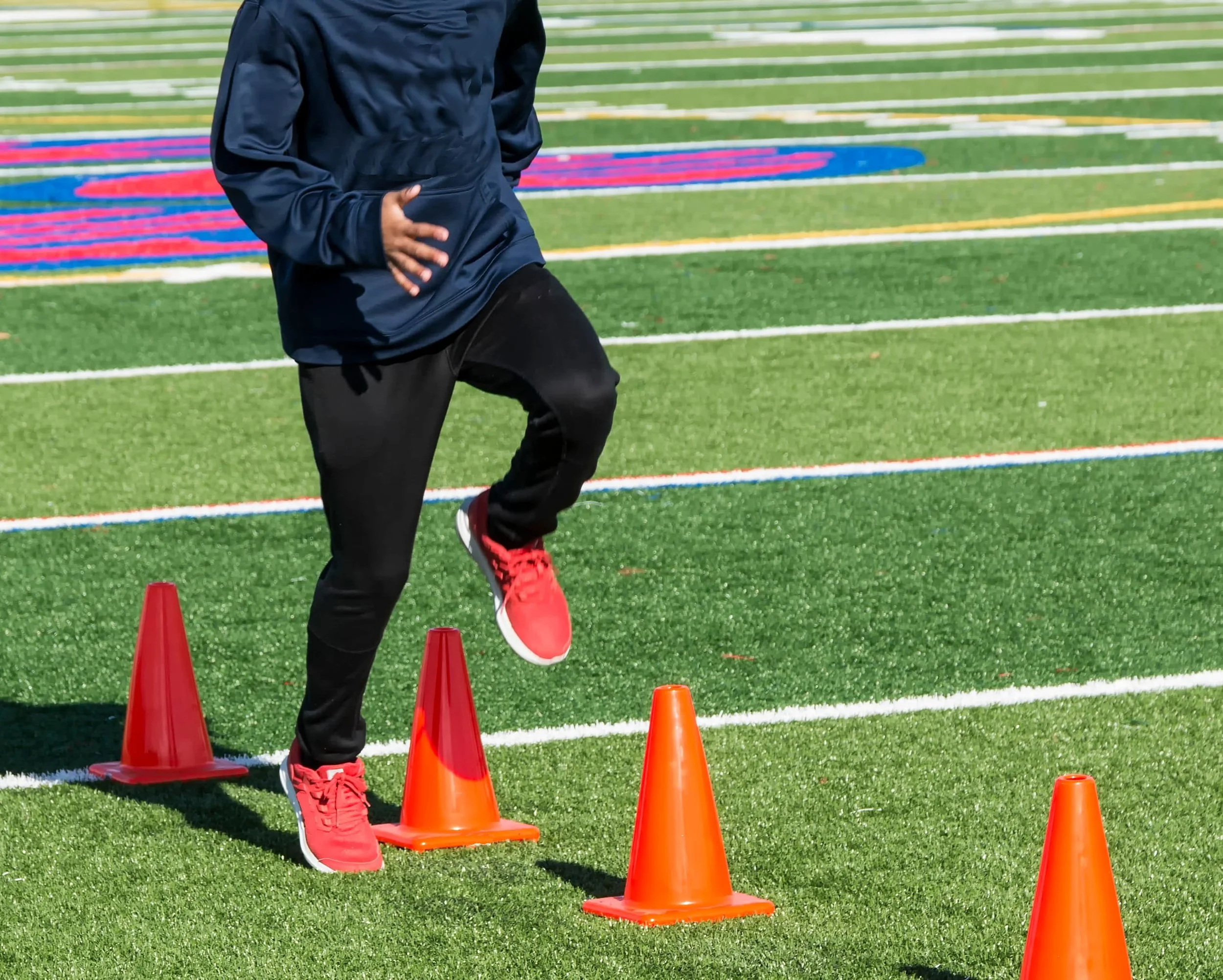 An athlete training on an American football field.