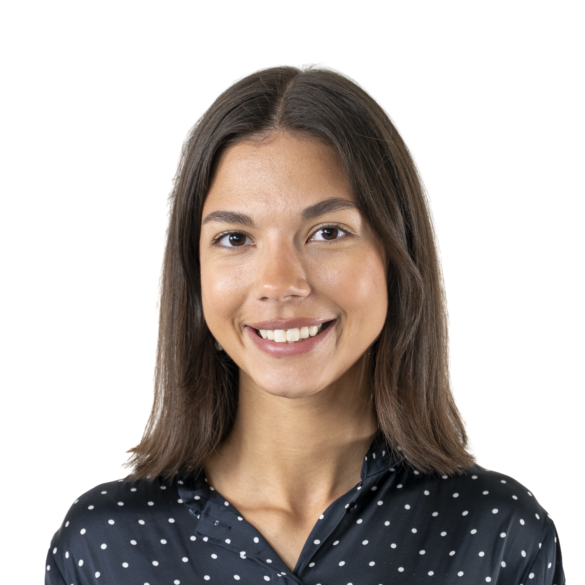 Close-up of a woman with brown hair, smiling, wearing a black polka-dot shirt.