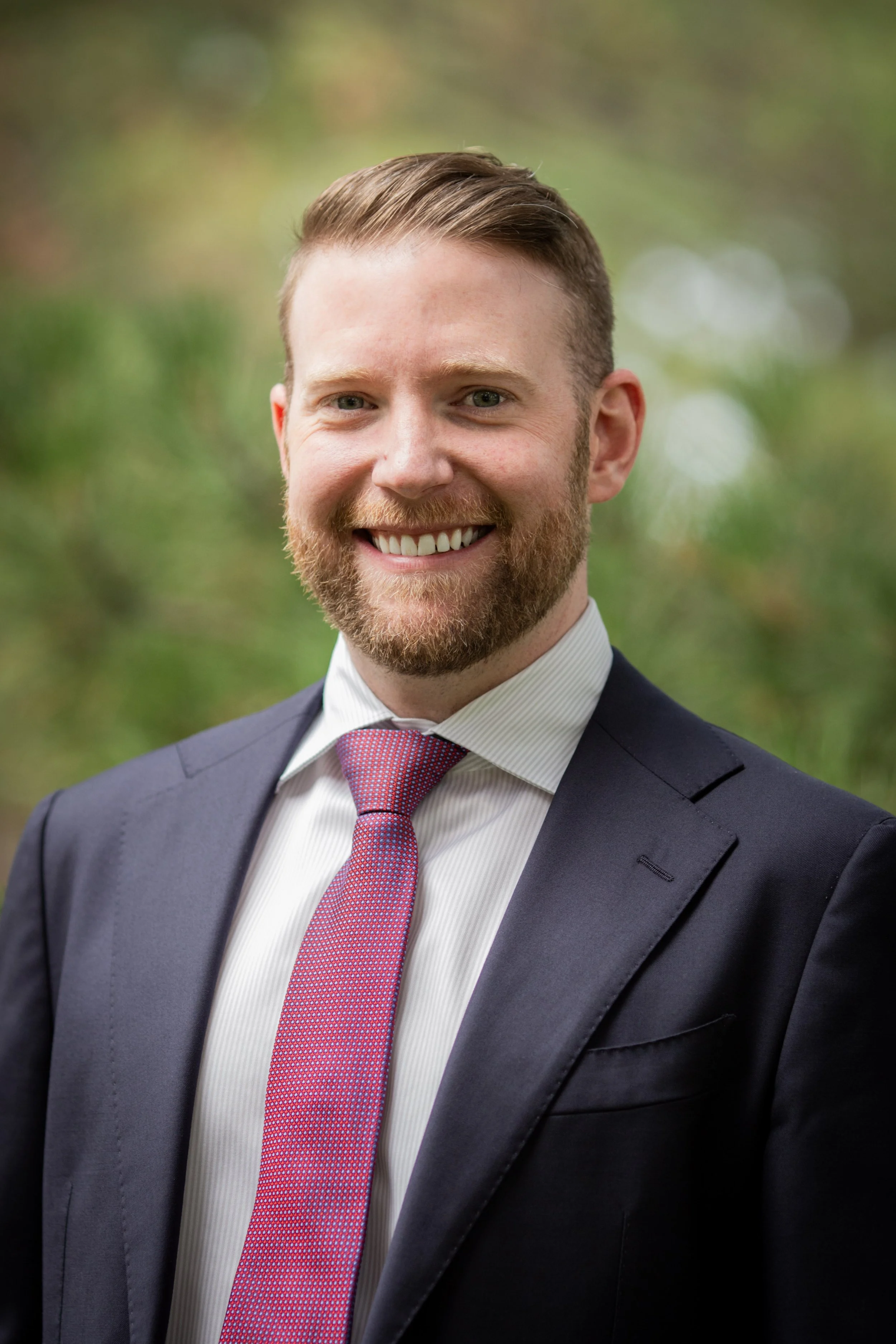 Headshot of Robby Voorhees, a white man in a suit