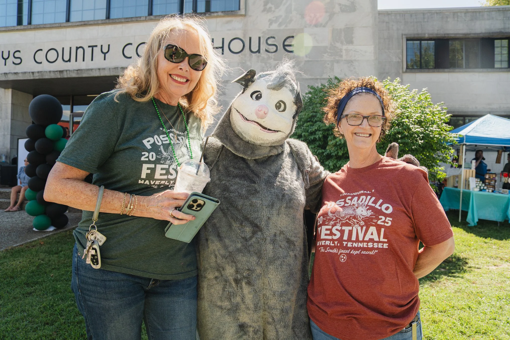 Two women and the possadillo mascot at the possadillo festival, outside the humphreys county courthouse