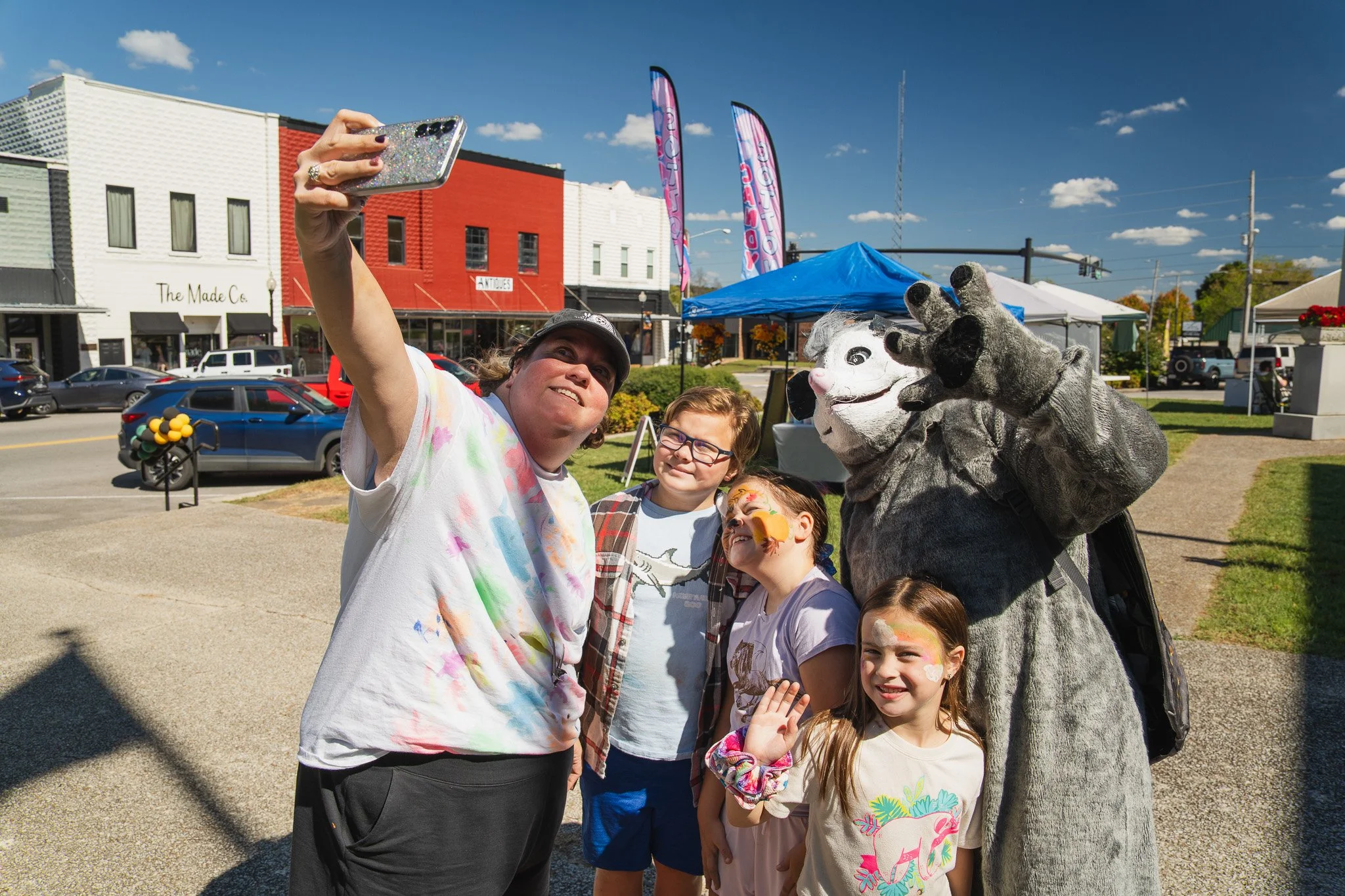 A group of people are taking a selfie together at the possadillo festival in Waverly Tennessee