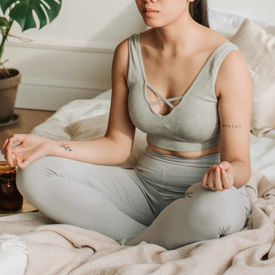 Woman practicing meditation and mindfulness in a calming home sanctuary