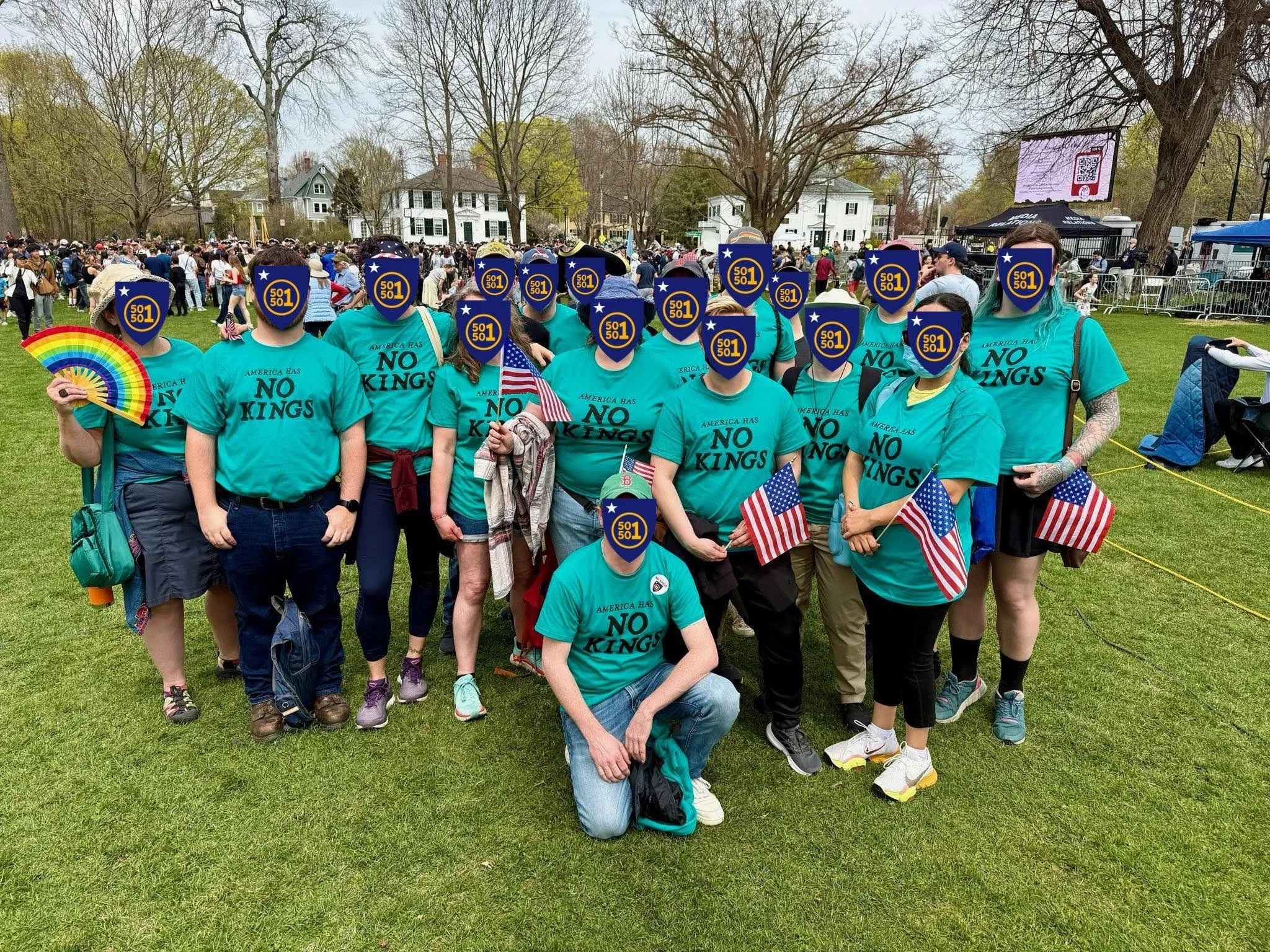 A group of volunteers wearing teal "No Kings" tshirts