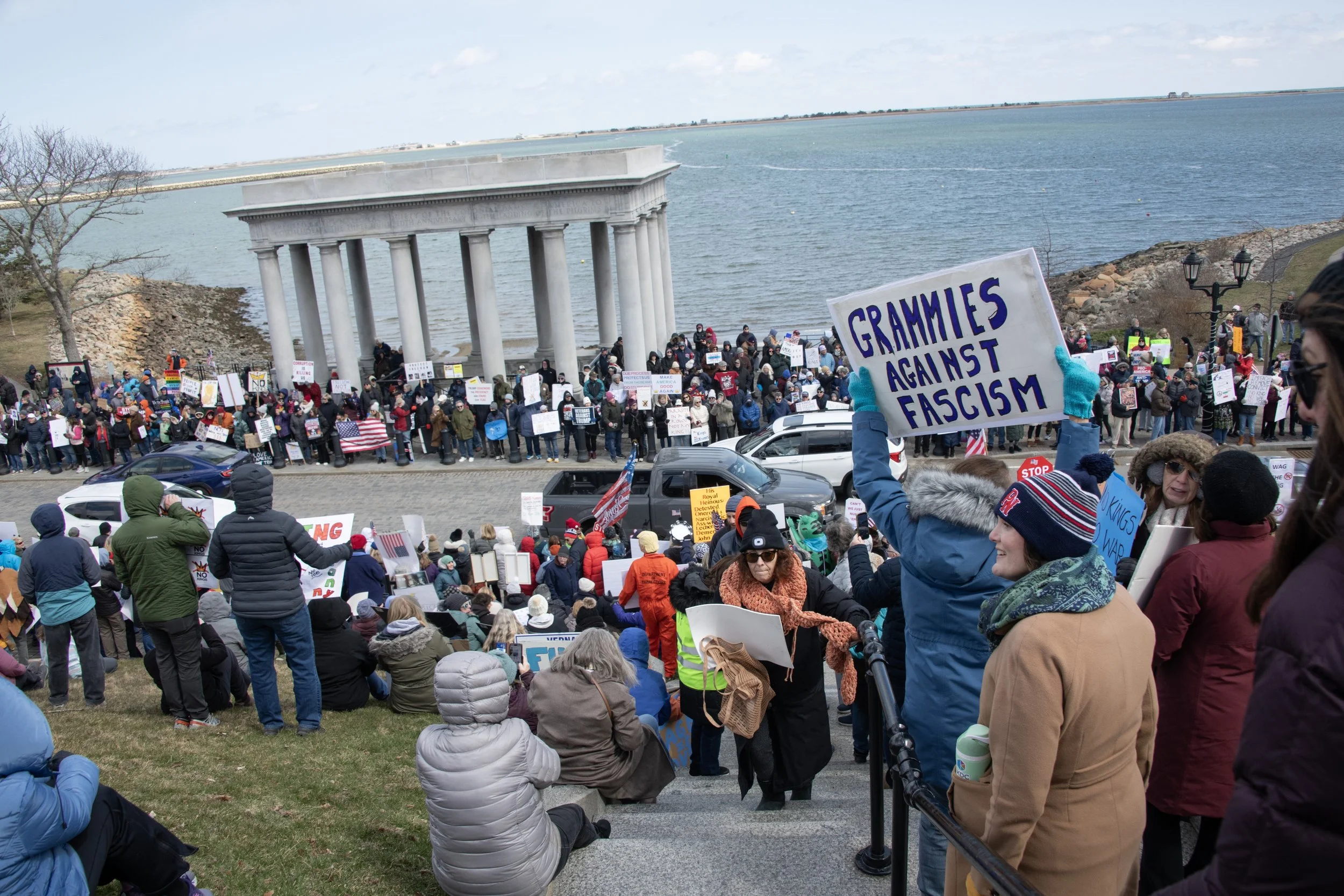 A sign that says "Grammies Against Fascism" in a crowd at No Kings III in Plymouth by Mass 50501.