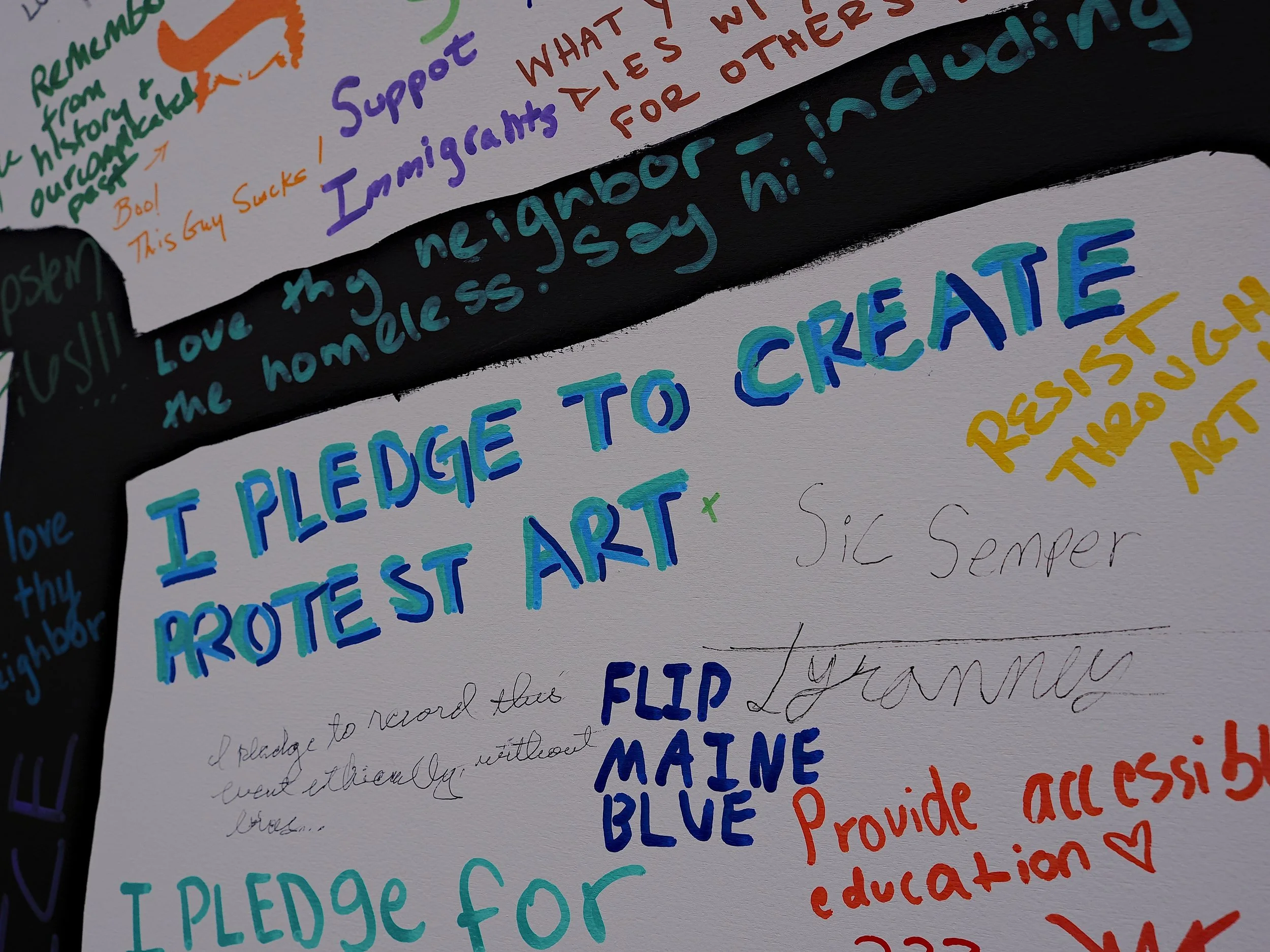 Mural close up that says "I pledge to create protest art" at No Kings III in Boston by Mass 50501.