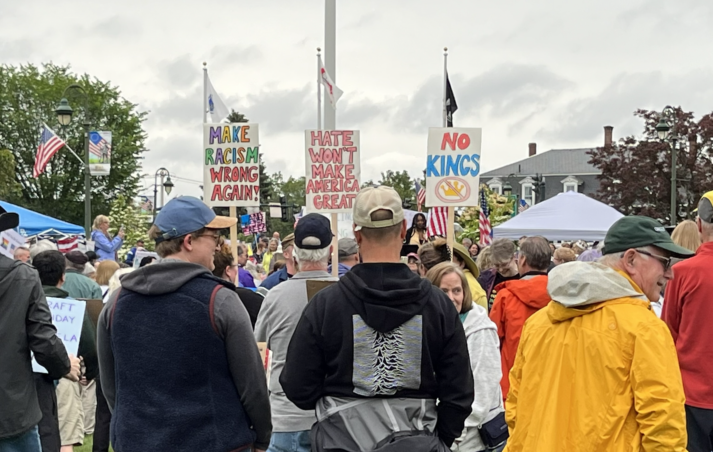 Protests in Chelmford holding signs saying "Make Racism Wrong Again", "Hate won't make America Great", and "No Kings"