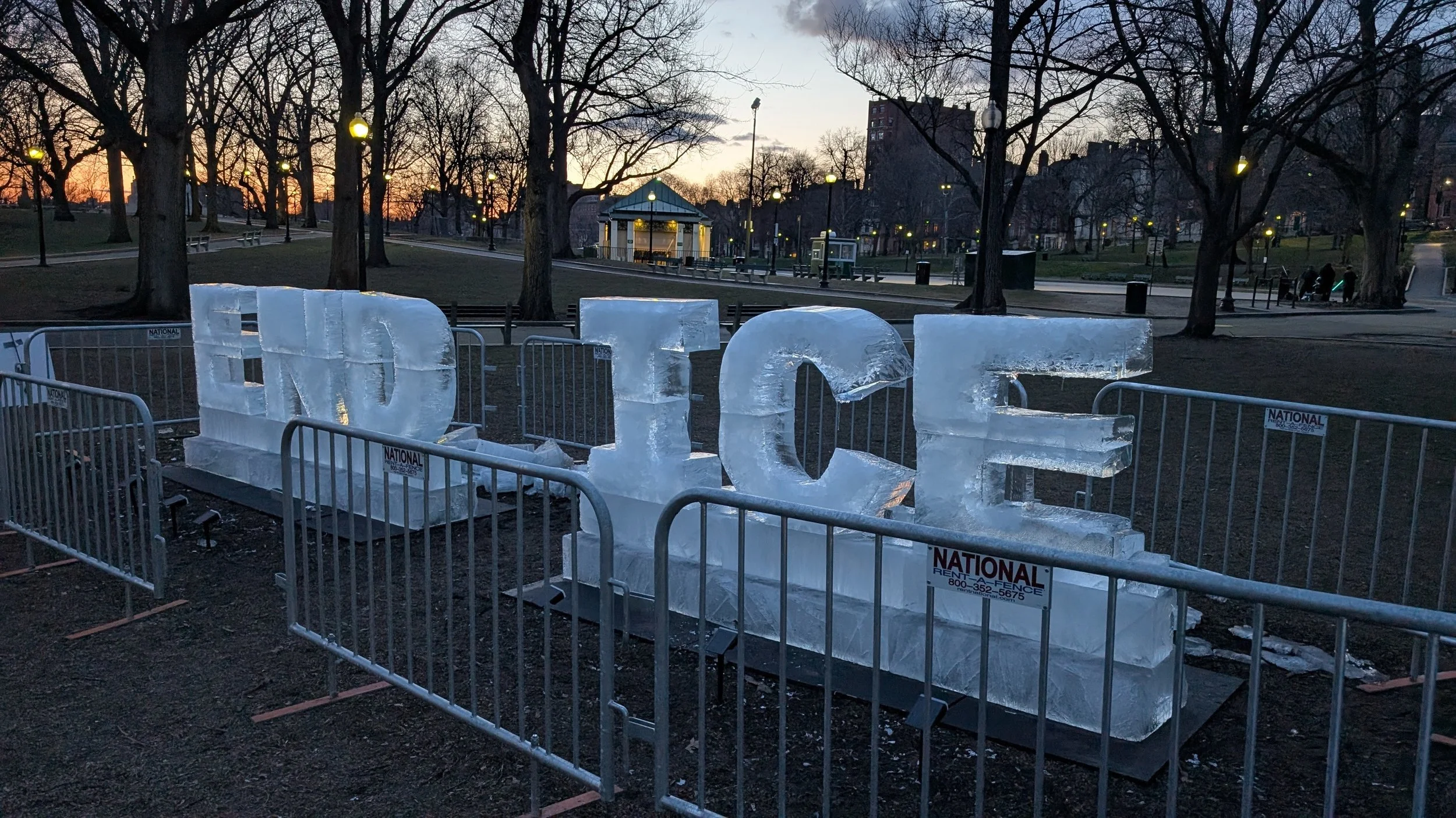 Ice sculpture by Kat Dressler that says "END ICE" at No Kings III in Boston by Mass 50501.