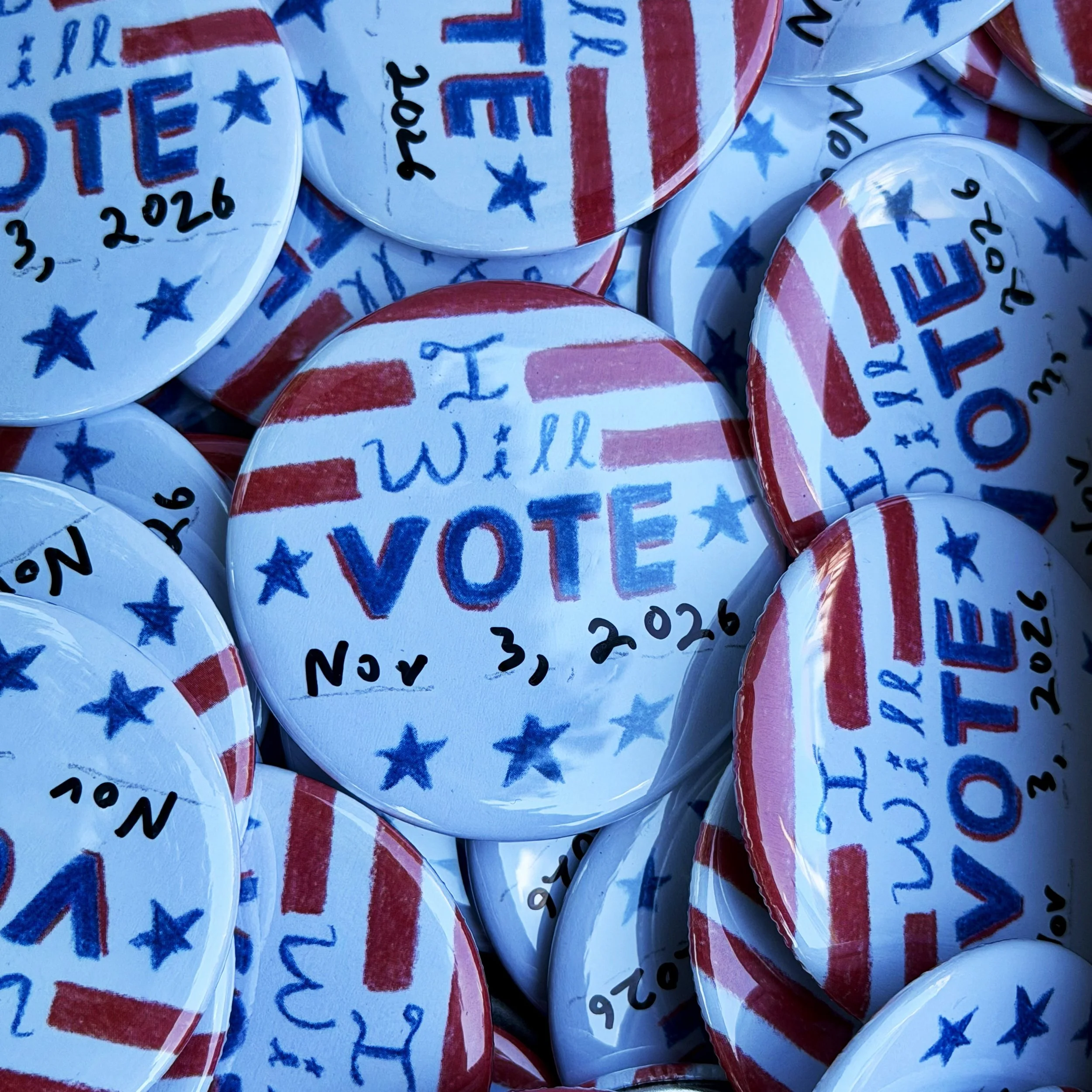 A collection of buttons saying “I will vote Nov. 3, 2026”.