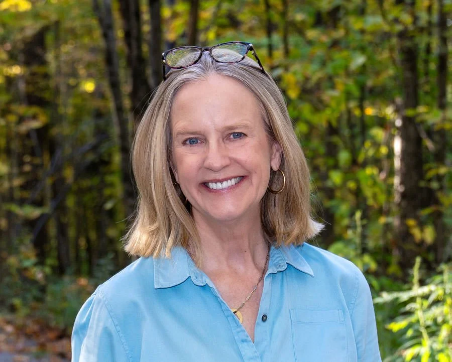 portrait of a woman with a fall foliage backdrop