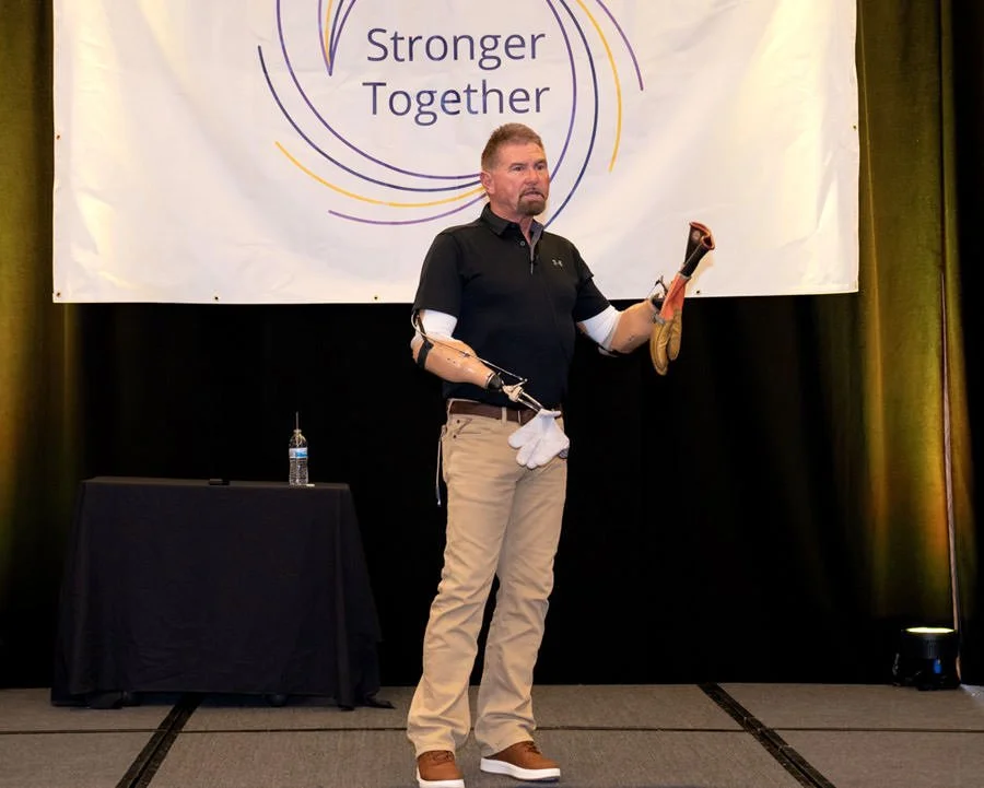 a man with prosthetic arms is giving a safety presentation