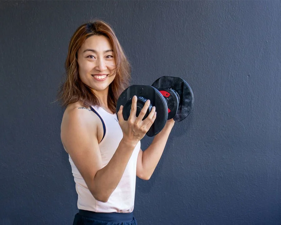 portrait of a fitness trainer holding weights