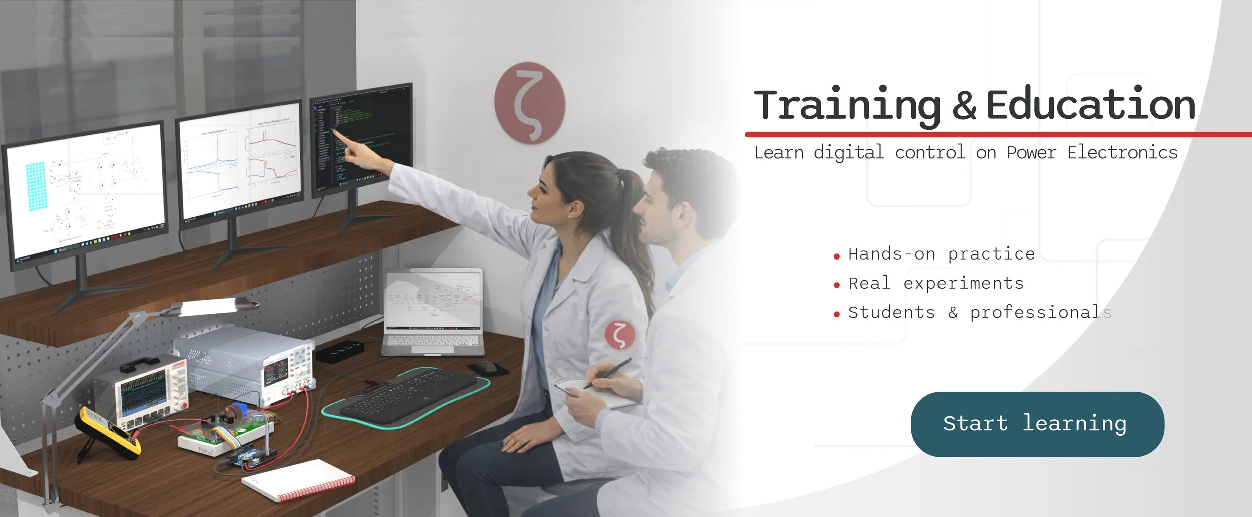 Two women in lab coats working on digital control experiments on desktop computers with multiple monitors displaying graphs and circuit diagrams, in a classroom or laboratory setting.