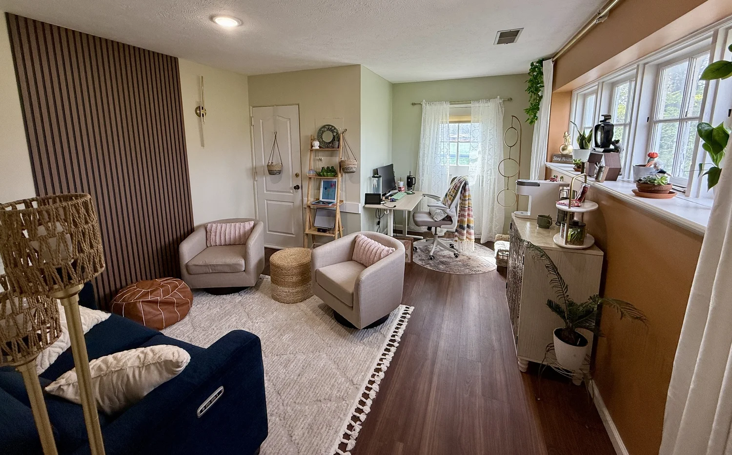 Inside Gravity's office, with a navy sofa, comfortable armchairs, plants, and natural light.