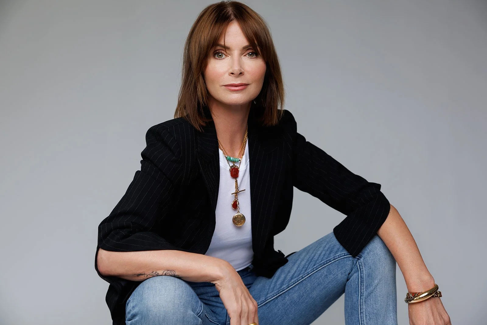commercial photography and portrait of a woman jewelry artist wearing handmade gold earrings in a branding photo
Branding headshot of a female jewelry designer in studio light
Professional portrait of Rhode Island jewelry artist wearing statement nec