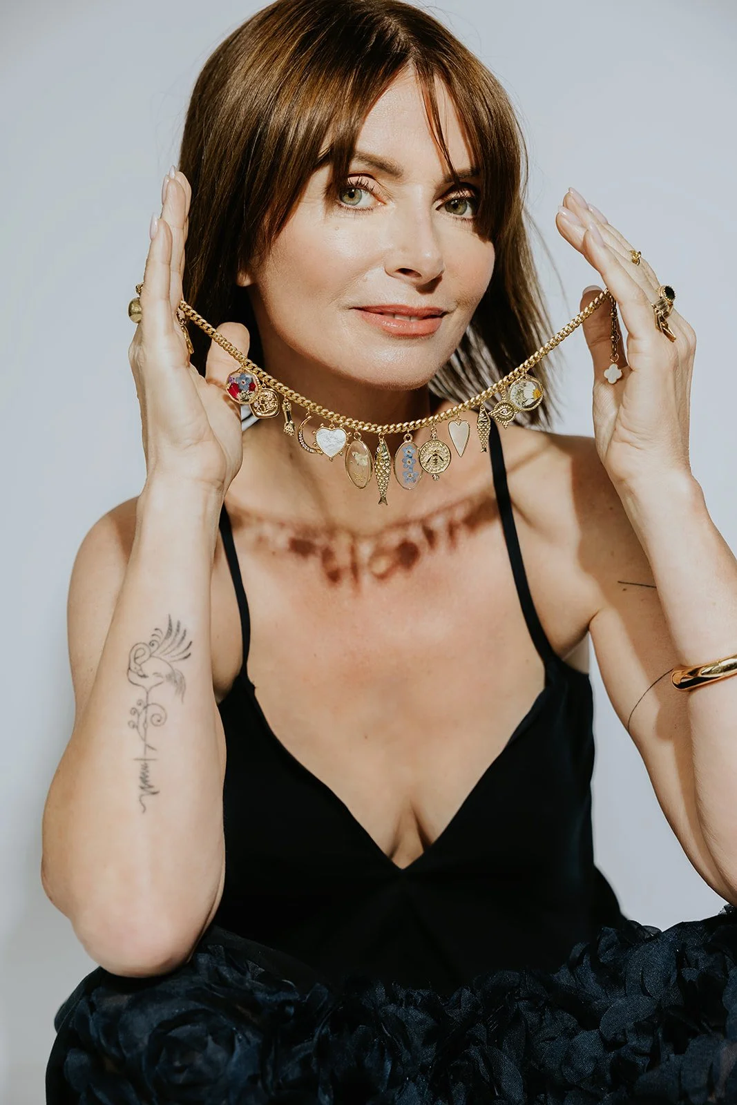 commercial photography and portrait of a woman jewelry artist in a branding photo
Branding headshot of a female jewelry designer in studio light
Professional portrait of Rhode Island jewelry artist showing her custom jewlery
