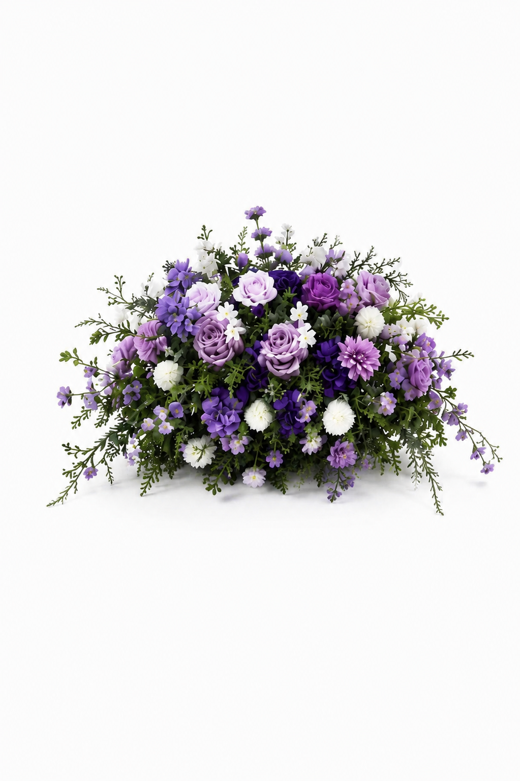 Purple arrangement: Lush floral arrangement featuring lavender and deep-purple roses, purple daisies, small white blossoms, and cascading greenery on a white background.
