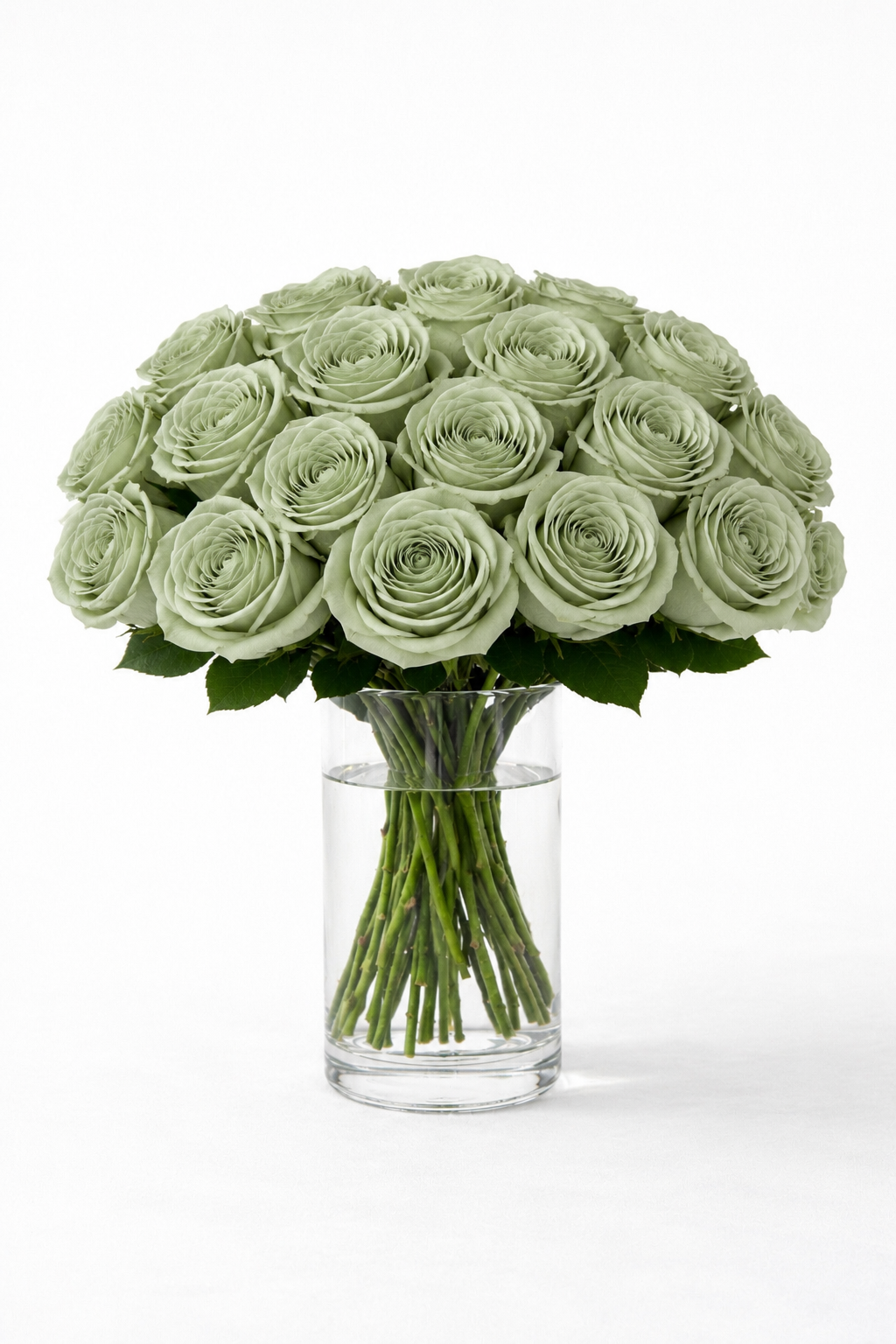 Realistic artificial long stem sage green roses arranged in a clear glass cylinder vase.