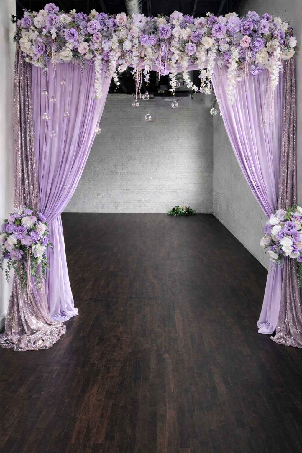 Lavender and blush floral entrance arch with soft draping, cascading flowers, and elegant doorway backdrop for weddings and special events