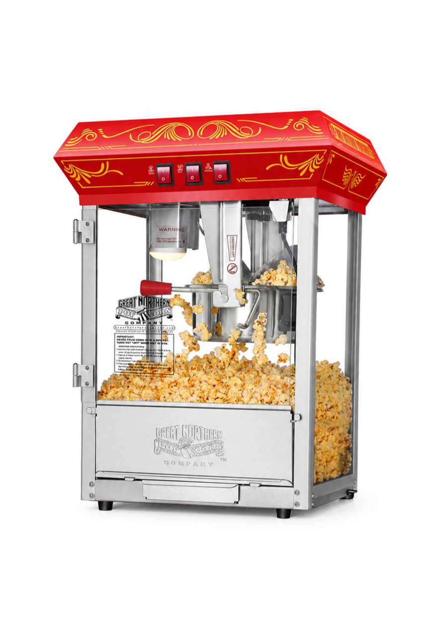 Red and silver tabletop popcorn machine filled with freshly popped popcorn.