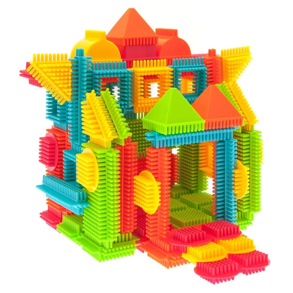 Colorful bristle blocks assembled into a house structure with interlocking textured pieces for kids play