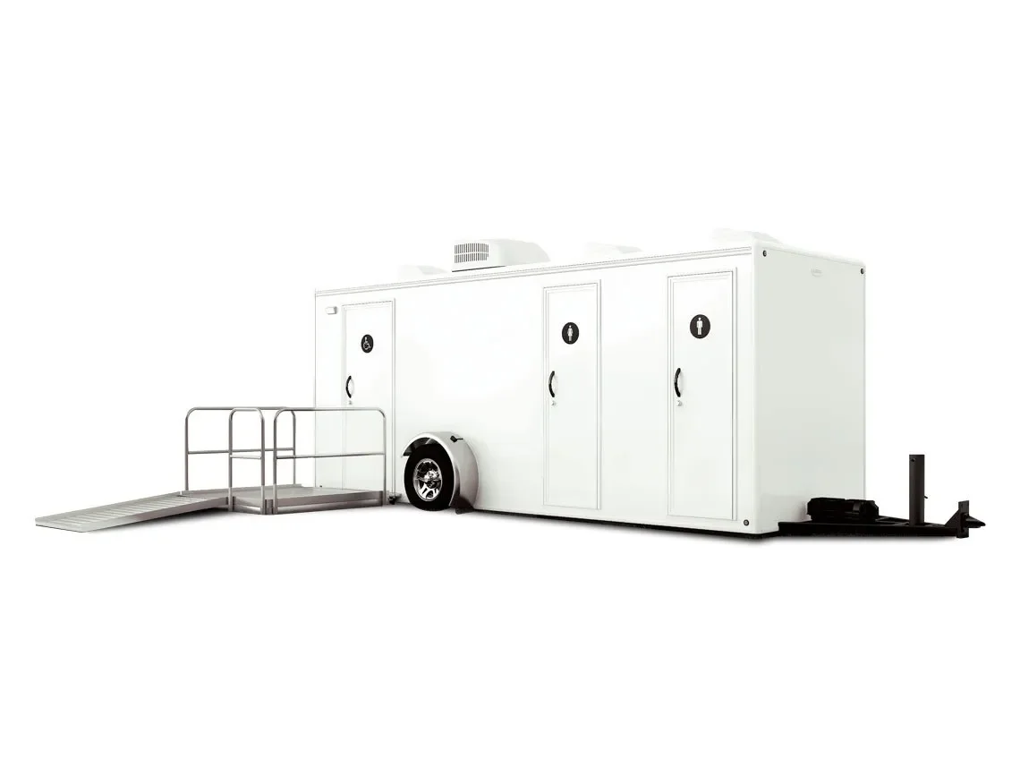 White portable restroom trailer with multiple stall doors and an accessible ramp Ada restroom attached