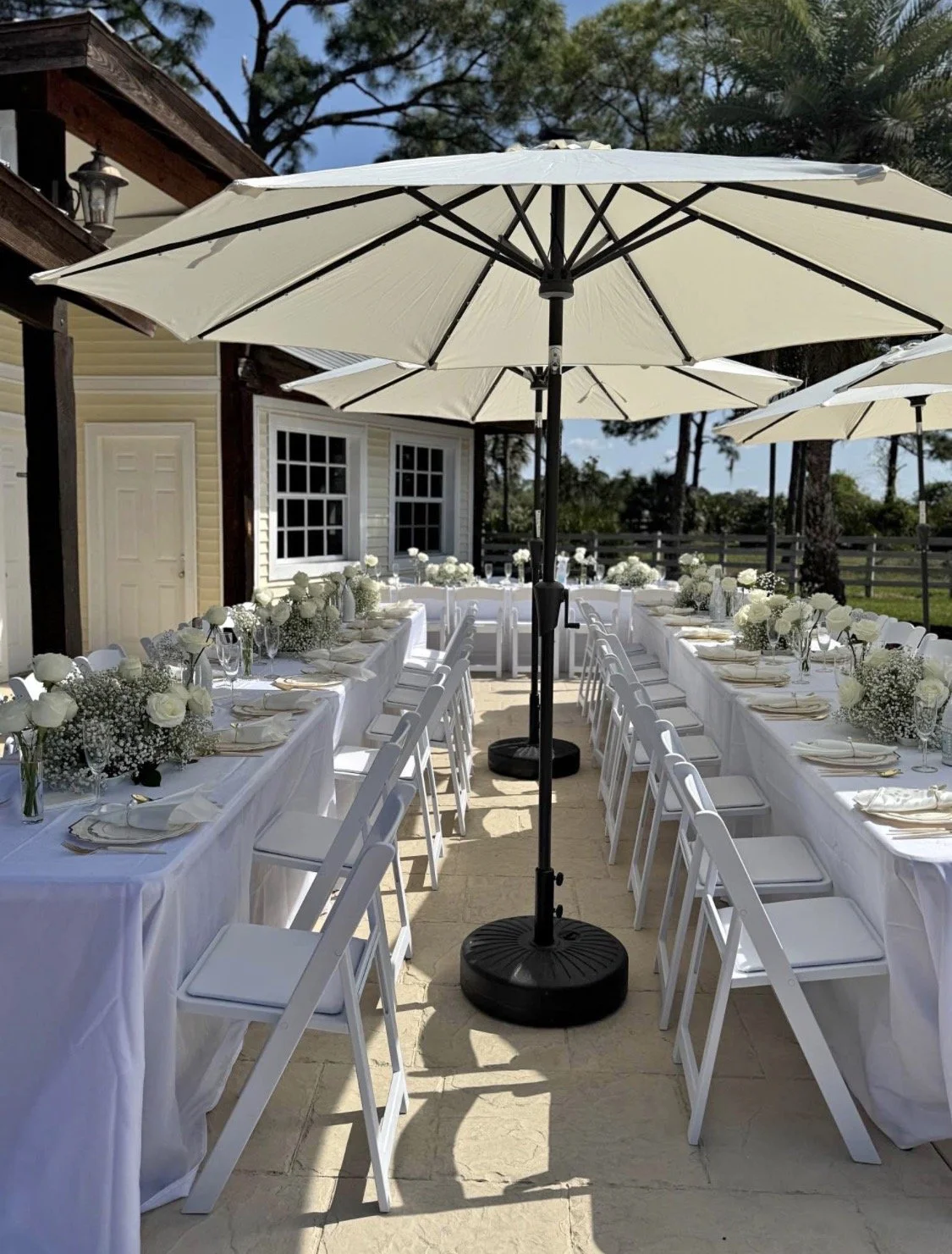 Large outdoor shade umbrella for weddings and special events providing sun protection for guests at ceremonies, receptions, and outdoor gatherings.