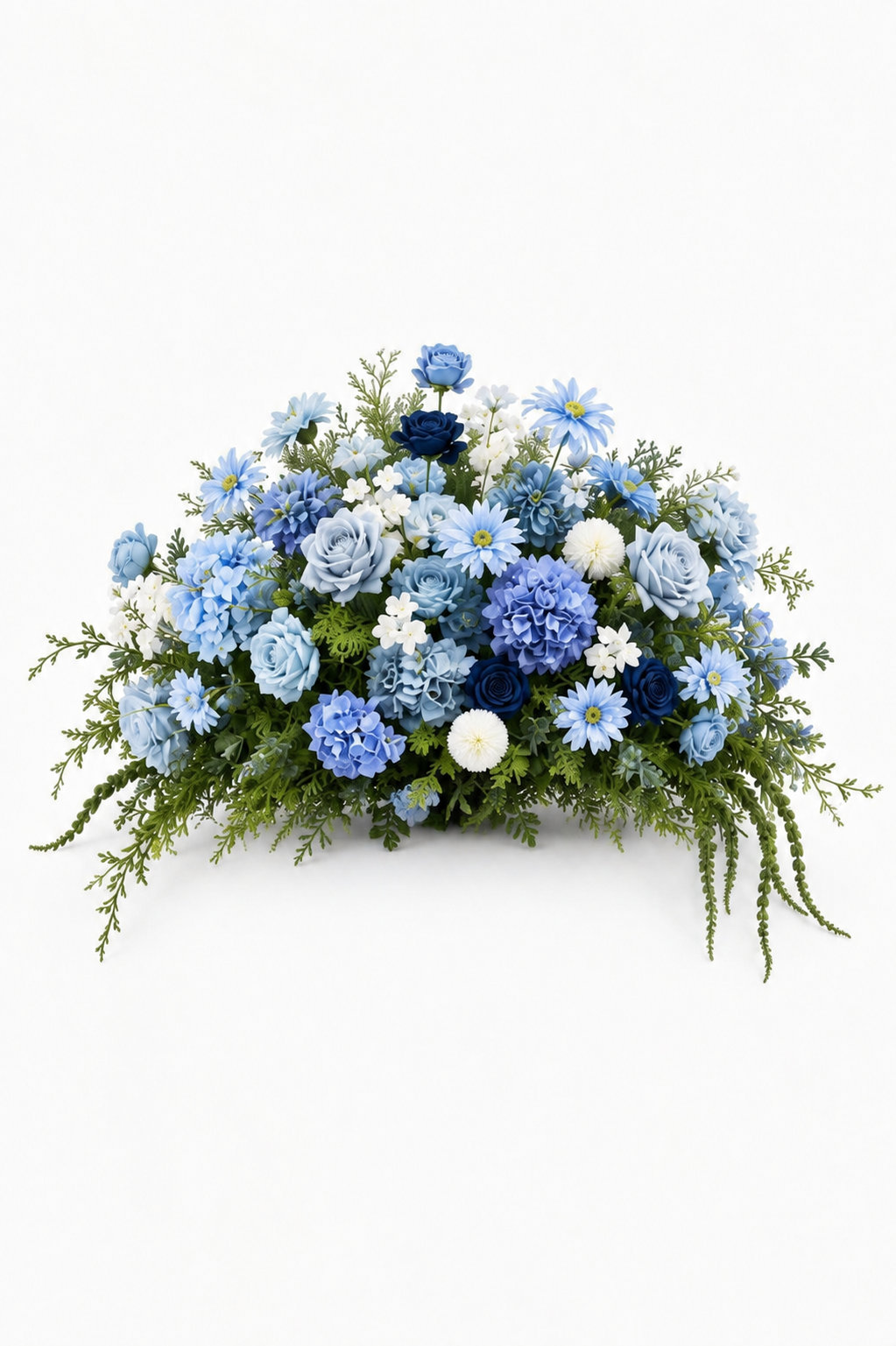 Blue arrangement: Full floral arrangement featuring light blue and navy roses, blue hydrangeas, daisies, white accent flowers, and cascading greenery on a white background.
