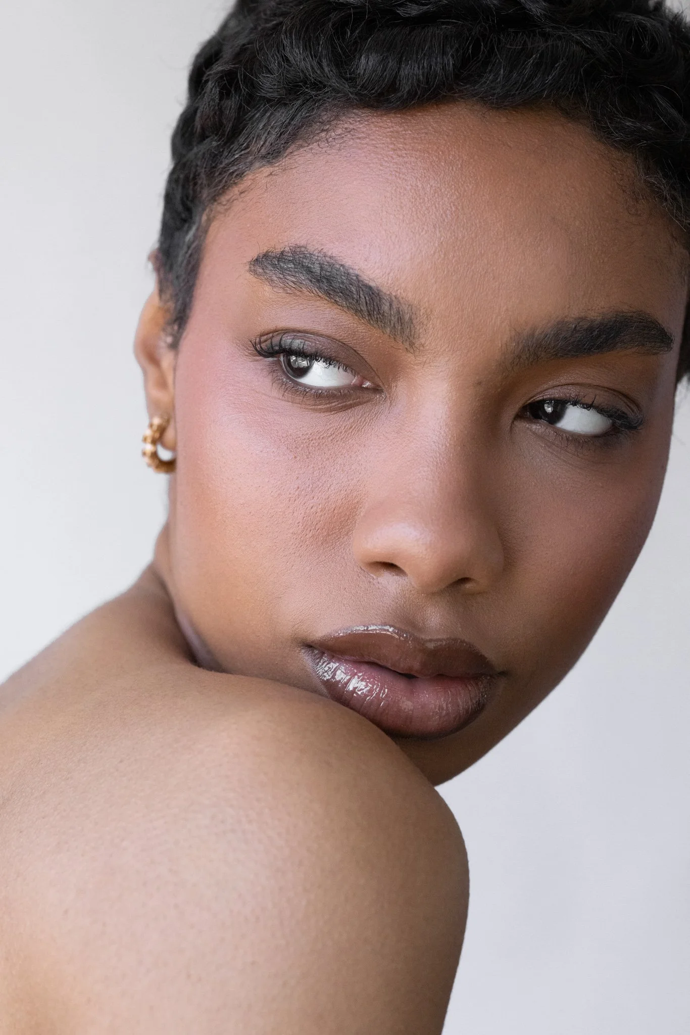 Editorial beauty portrait showcasing professional makeup artistry, captured using soft natural window light in Melbourne.