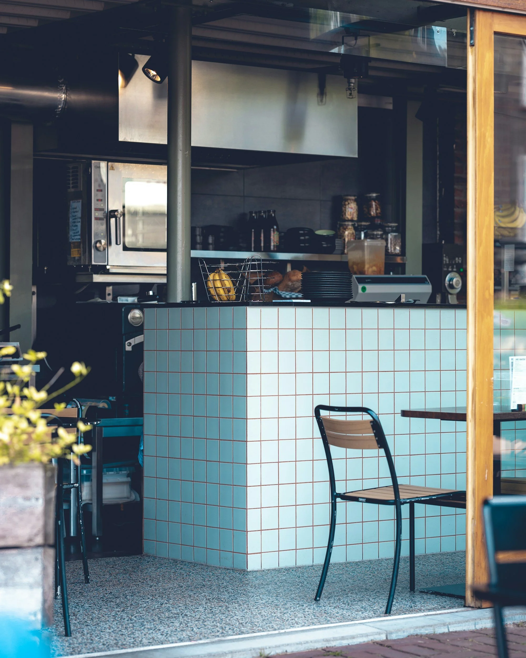 cafe with blue tiled counter and table and chairs