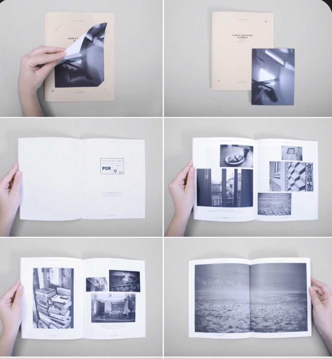 A person flipping through a photo book with black and white photographs of various scenes, including indoor and outdoor settings, architecture, and textures.