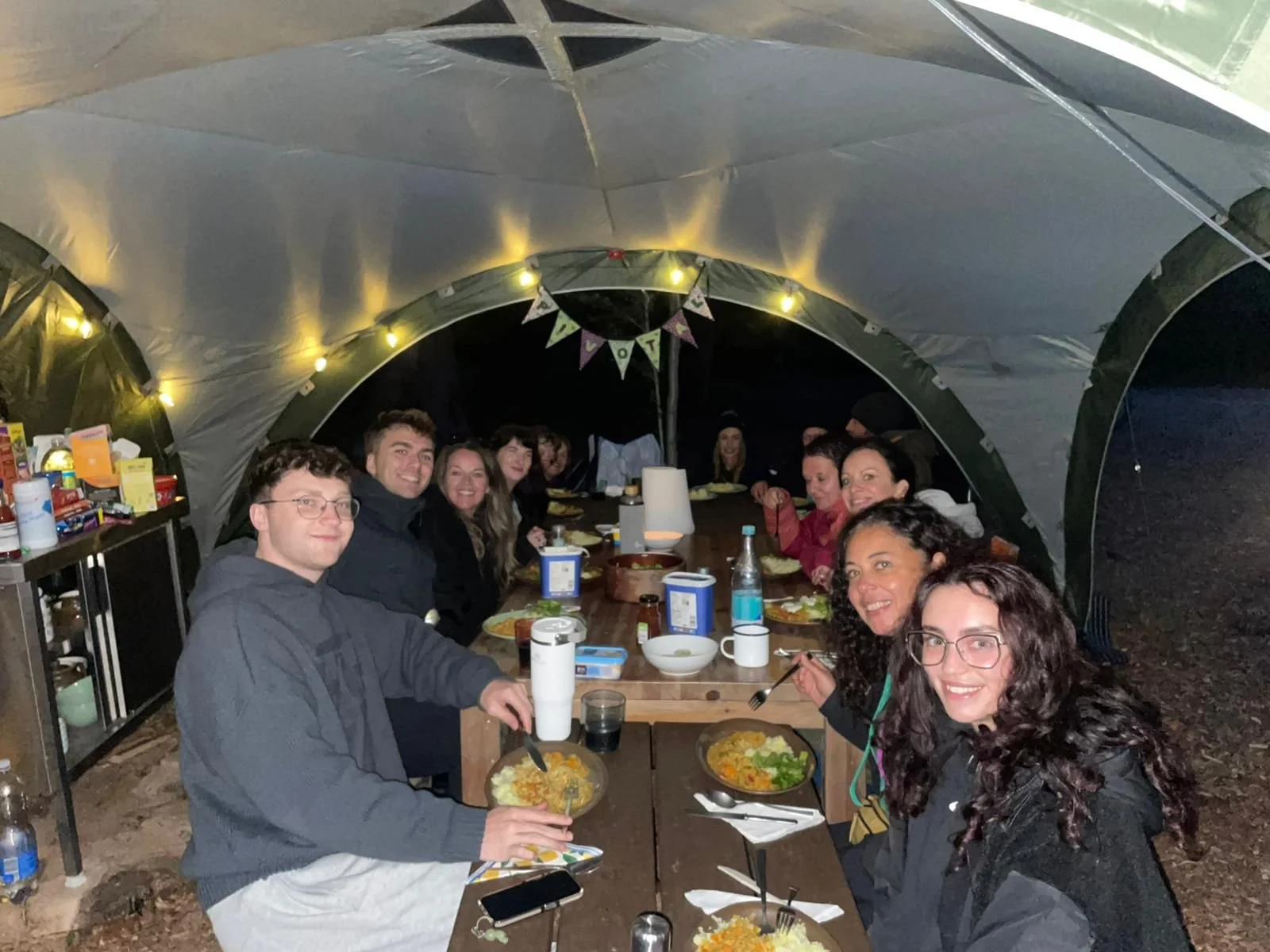 Group dinner in the covered communal dining area at night