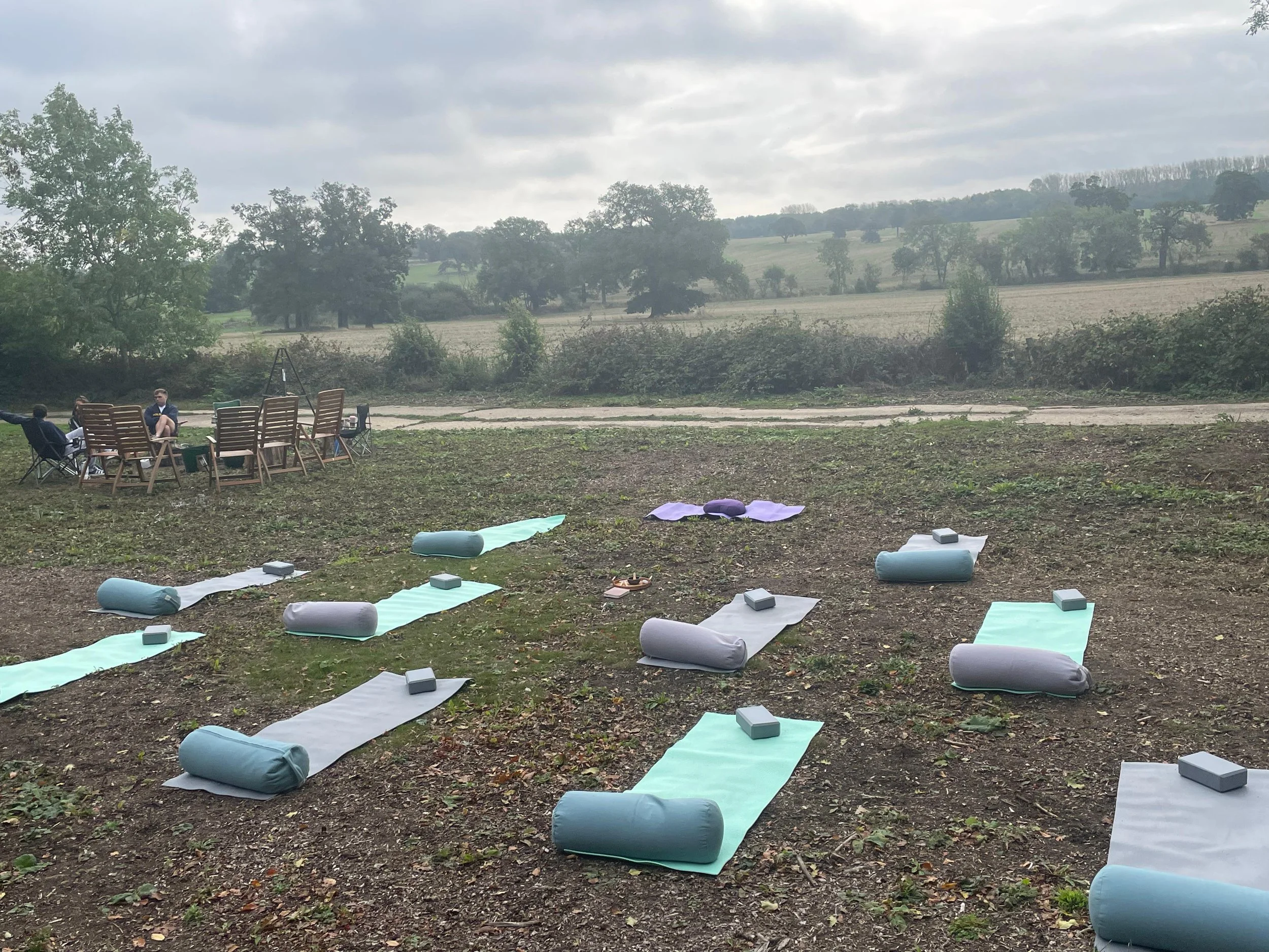 Yoga mats set out in rolling countryside for a retreat at The Grove