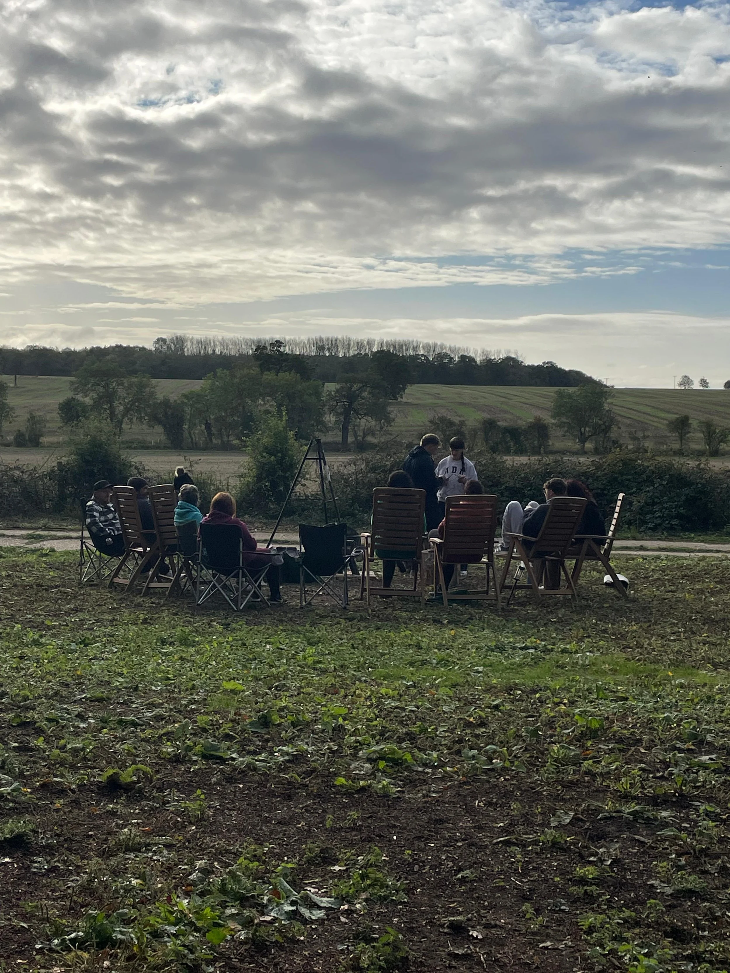 Guests gathered in chairs with countryside views at The Grove