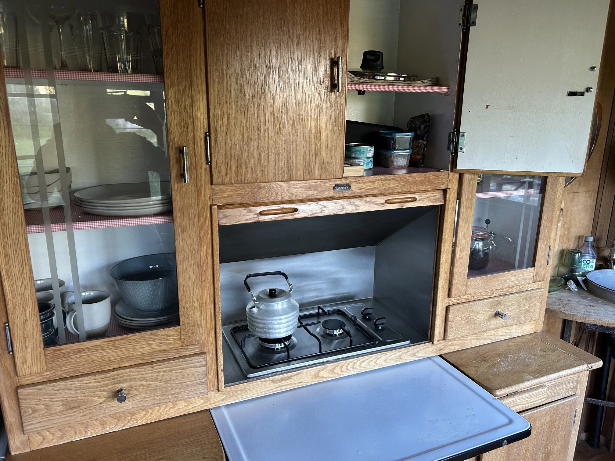 Vintage oak kitchen dresser with gas hob in shepherd's wagon glamping accommodation
