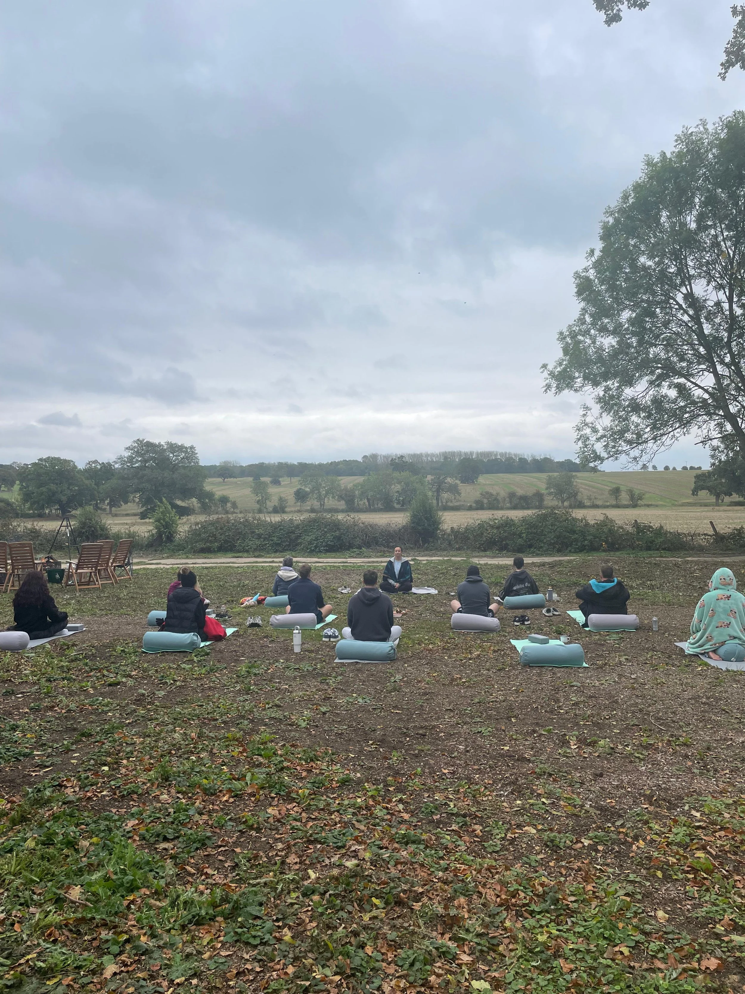 Outdoor yoga retreat session in open countryside at The Grove