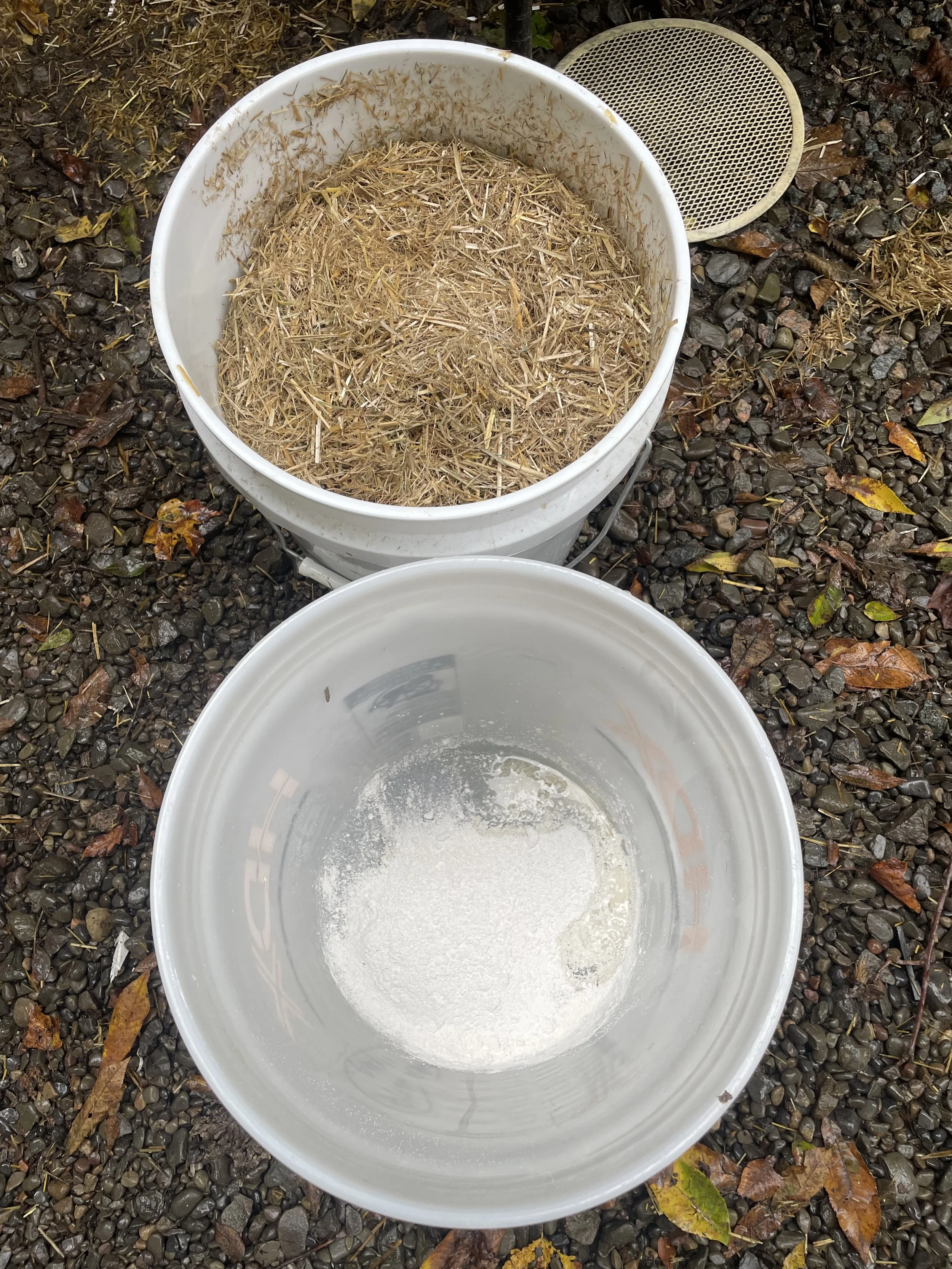 one bucket gets dry straw, the second is lime + water